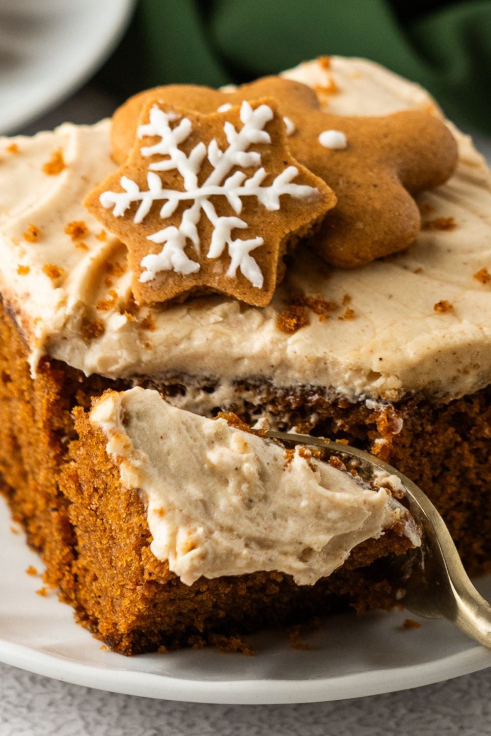 Gingerbread Cake with Cream Cheese Frosting slice on plate with a fork cutting some cake off