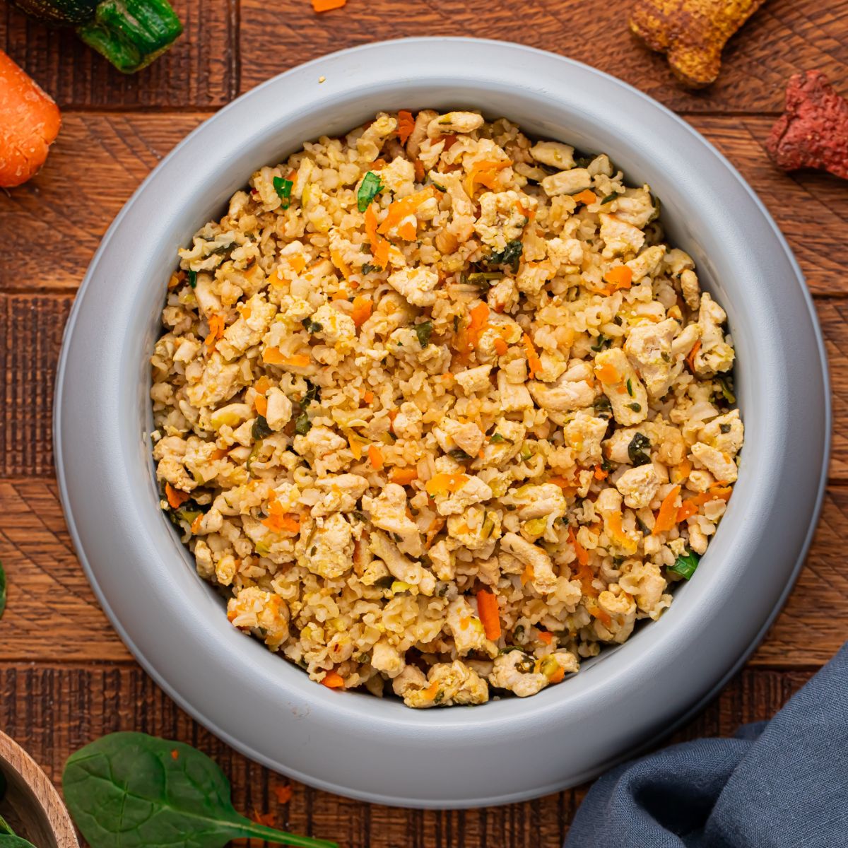 Homemade Turkey and Rice Dog Food with Veggies in a dog food bowl on table 