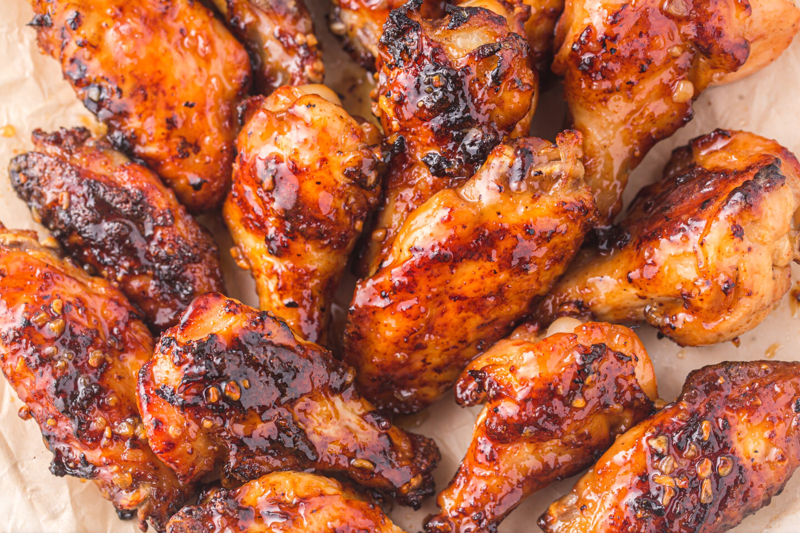 overhead shot of the Air Fryer Honey Garlic Chicken Wings on parchment paper 