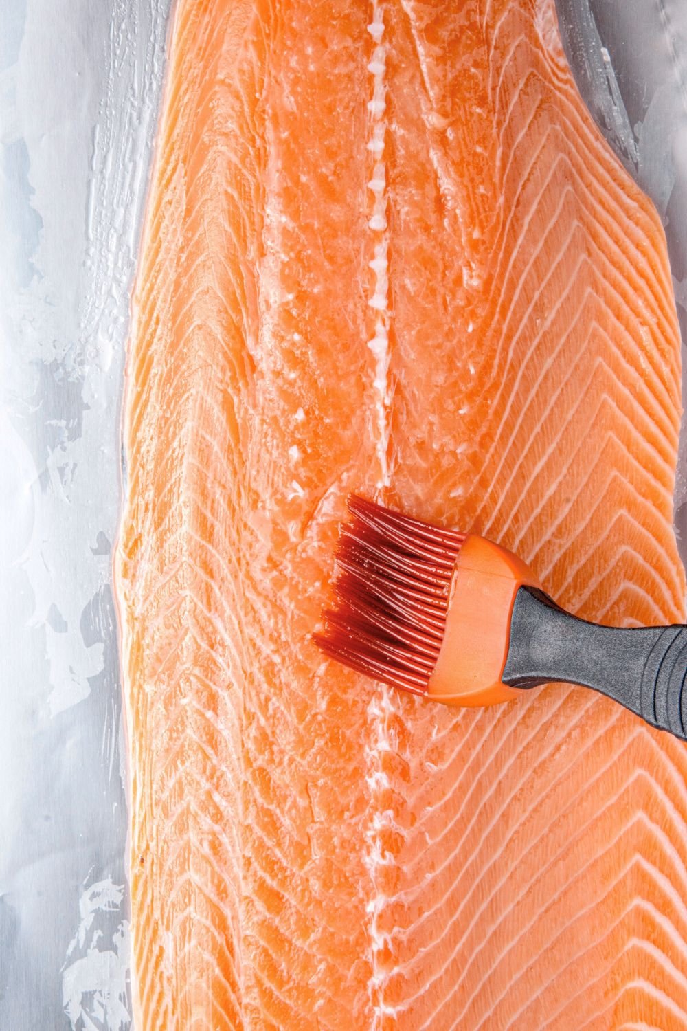brushing salmon fillet with oil 
