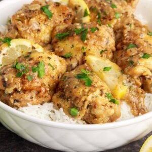 Instant Pot Lemon Butter Chicken in a bowl with rice under it on table