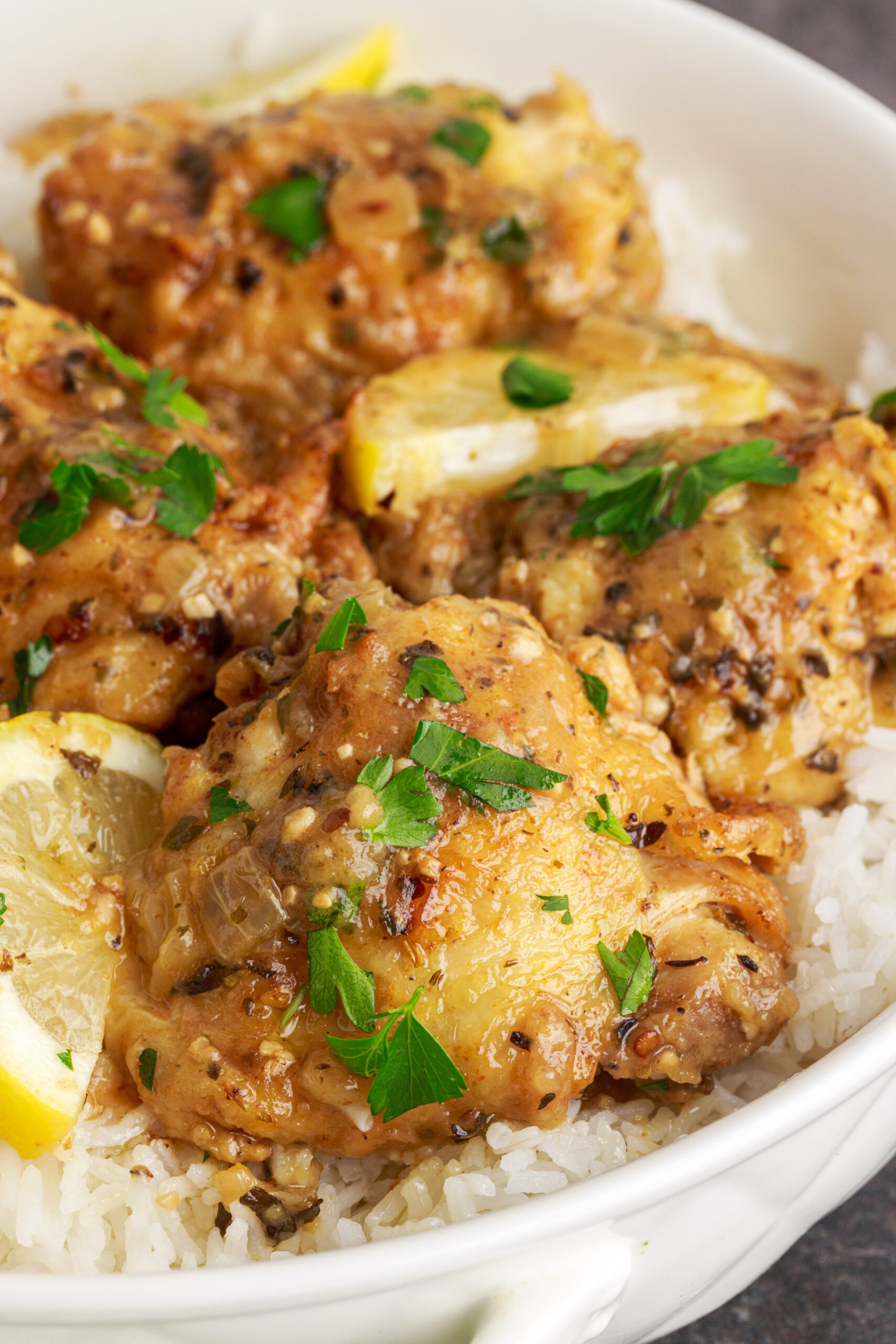 shot of the Instant Pot Lemon Butter Chicken in a white serving dish sitting on a table