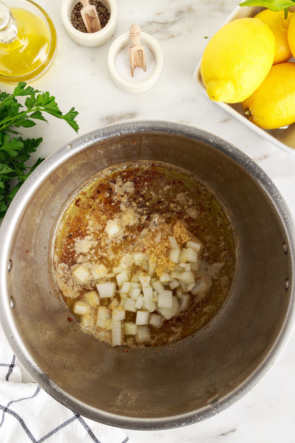 onions, garlic and more in Instant pot for making Instant Pot Lemon Butter Chicken