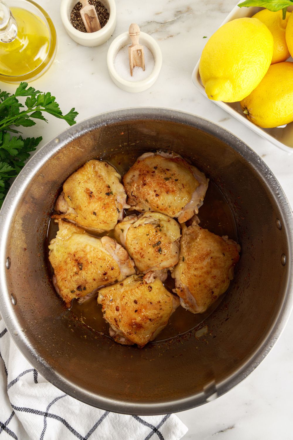 seared chicken in instant pot sitting on table for making Instant Pot Lemon Butter Chicken