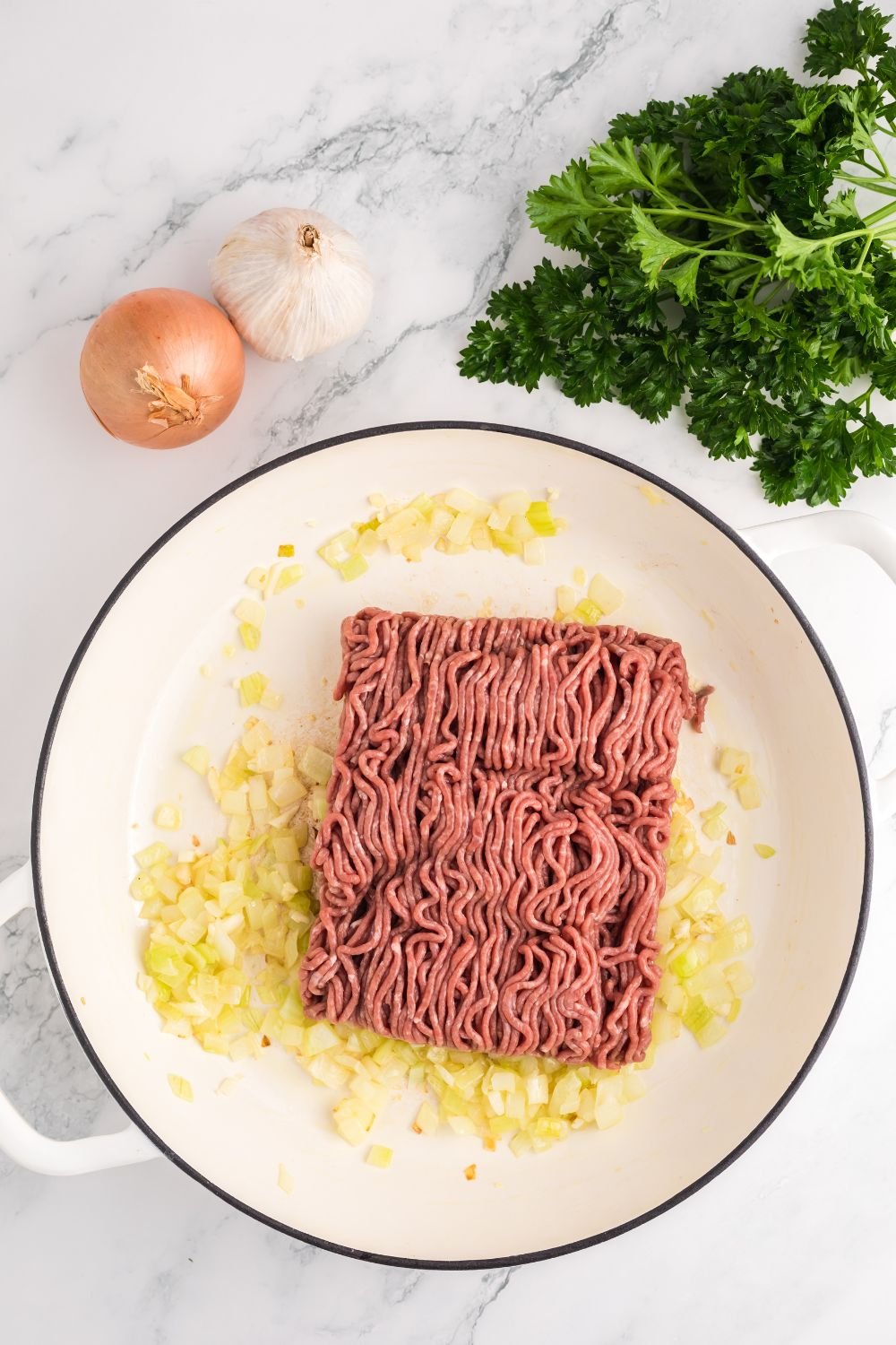 sauted onions with ground beef in pan 