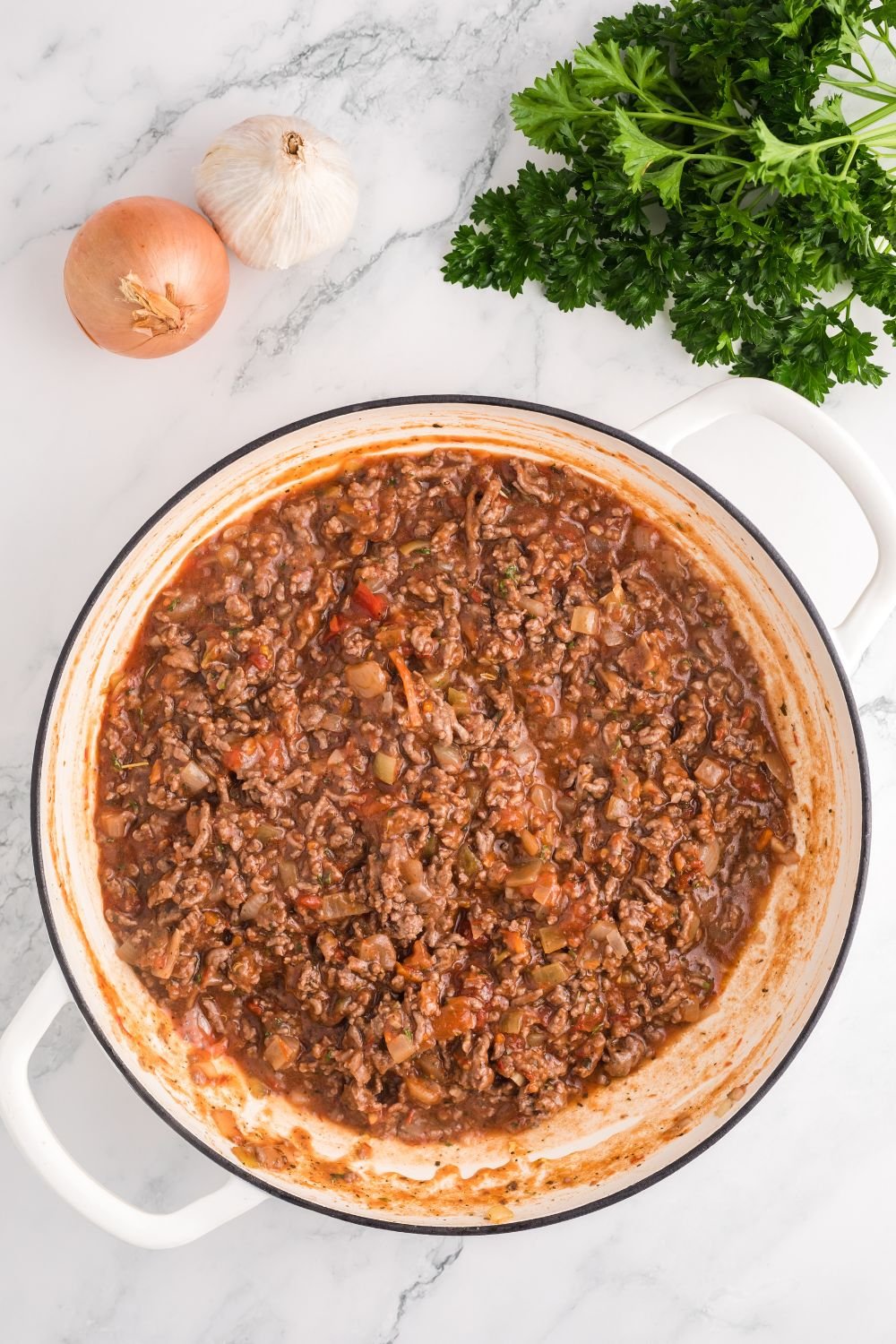 ground beef sauce in a skillet being cooked for Million Dollar Spaghetti Casserole