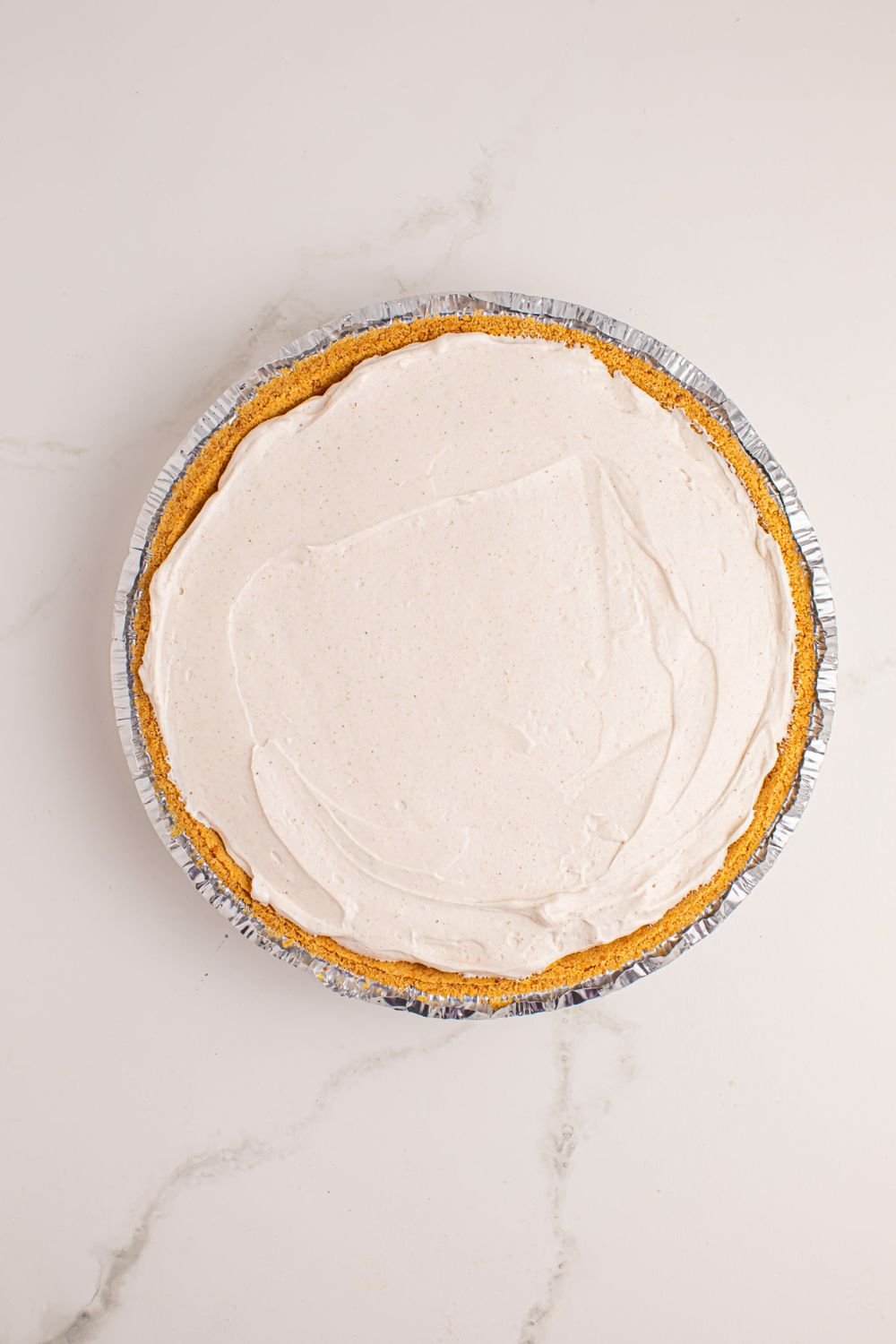 assemble of No Bake Apple Cheesecake in pie 