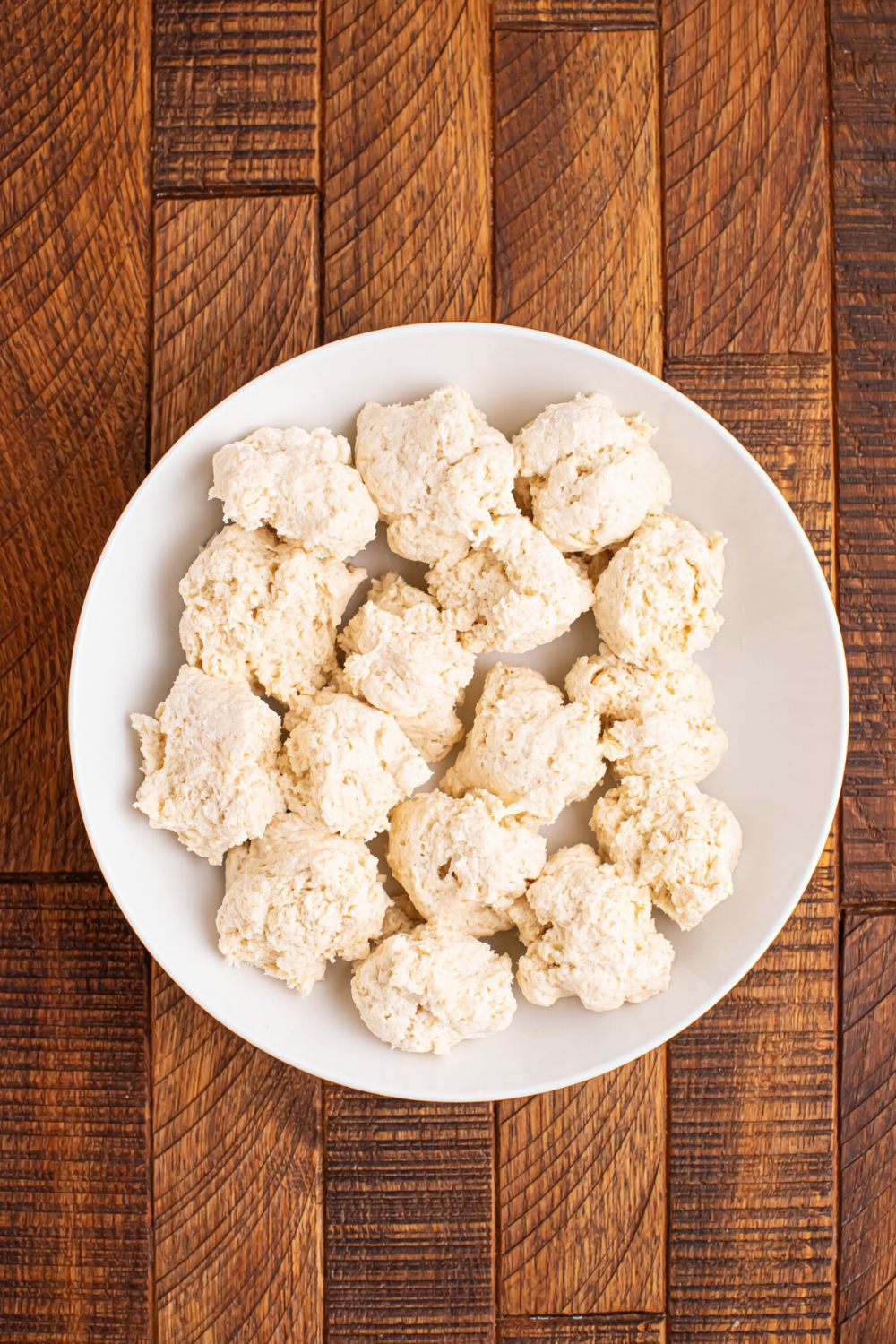 balls of 2 Ingredient Garlic Parmesan Breadsticks dough on a plate on the table 