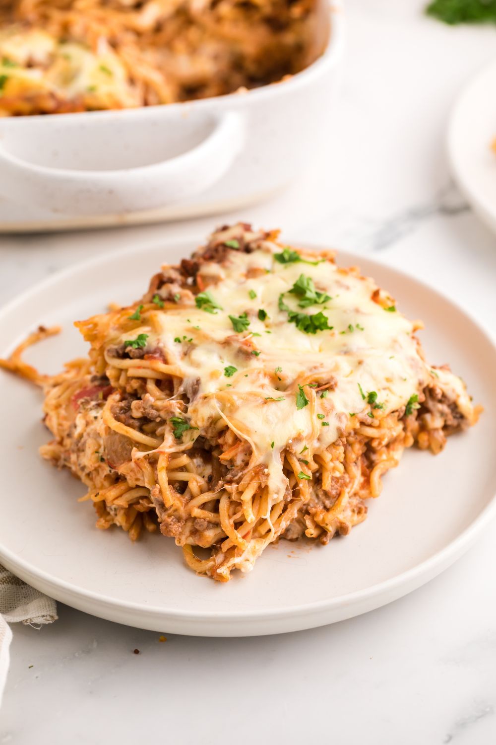 Million Dollar Spaghetti Casserole on a plate sitting on table 