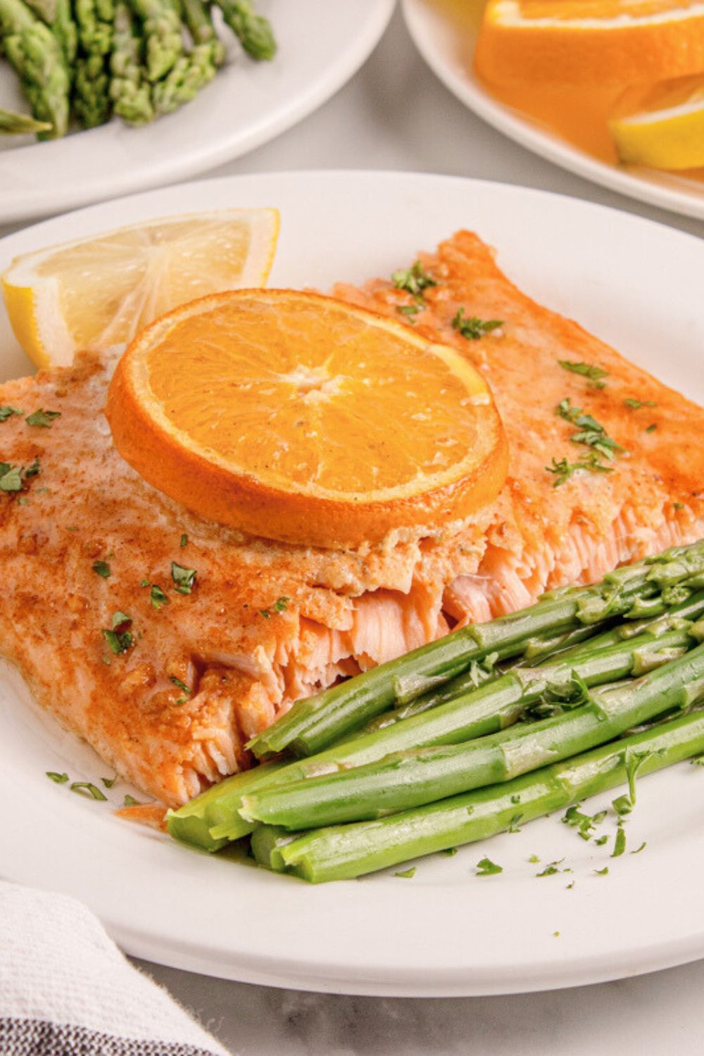 Grilled Honey Mustard Salmon on plate with asparagus and lemon wedge to side of plate 