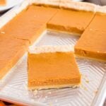 metal sheet pan sitting on table with a few slices of the pie gone to show how many slices of pie you get out of this slab pie recipe