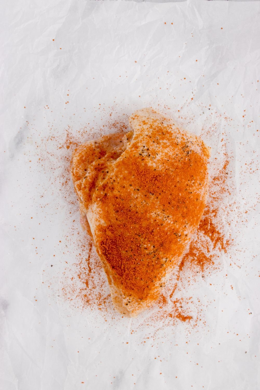 seasoned air fryer raw chicken on table