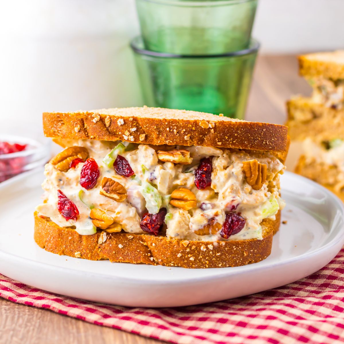 Thanksgiving Turkey Salad sandwich on plate with glasses and milk behind it on table 