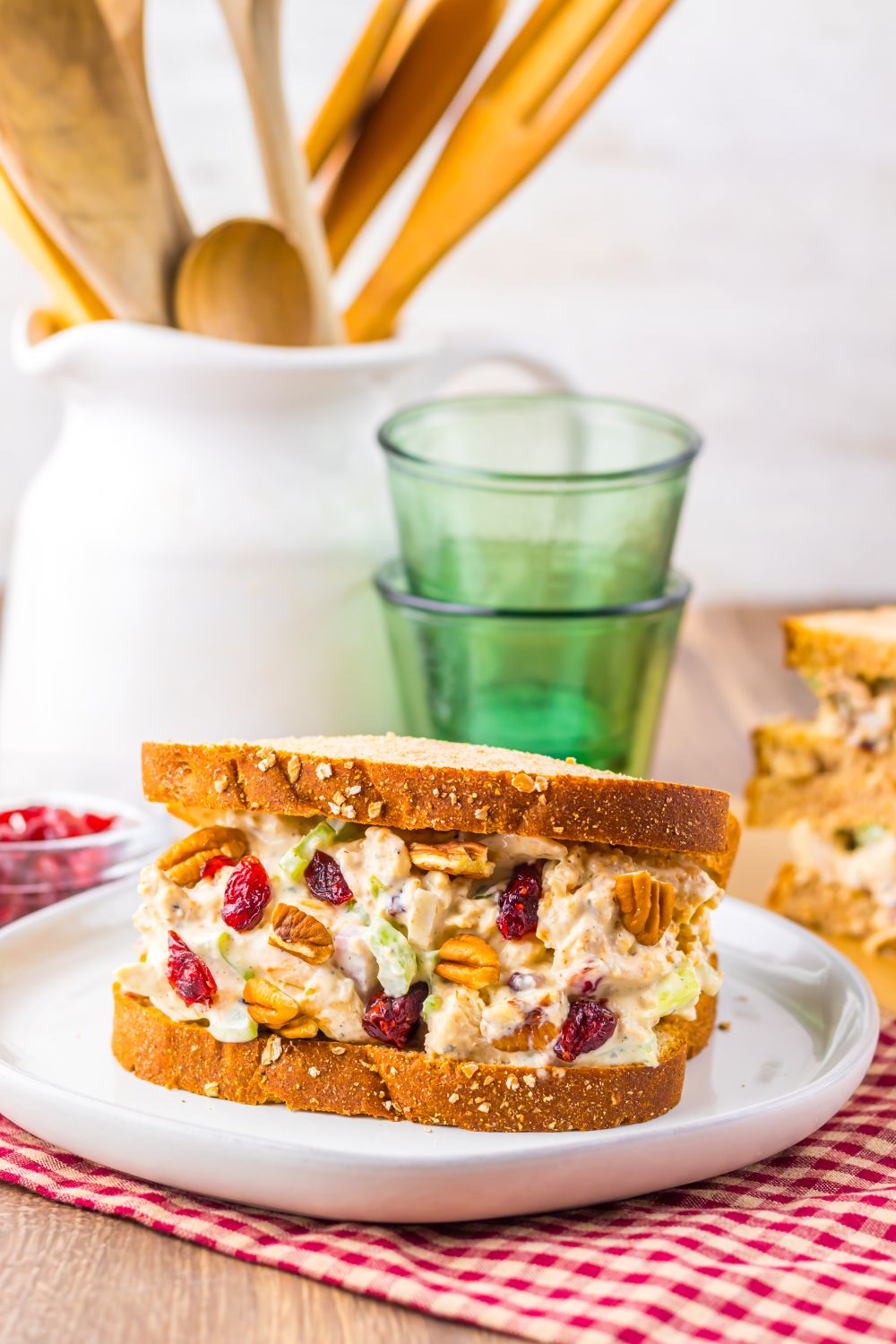 Thanksgiving Turkey Salad on plate with some glasses behind it on table 