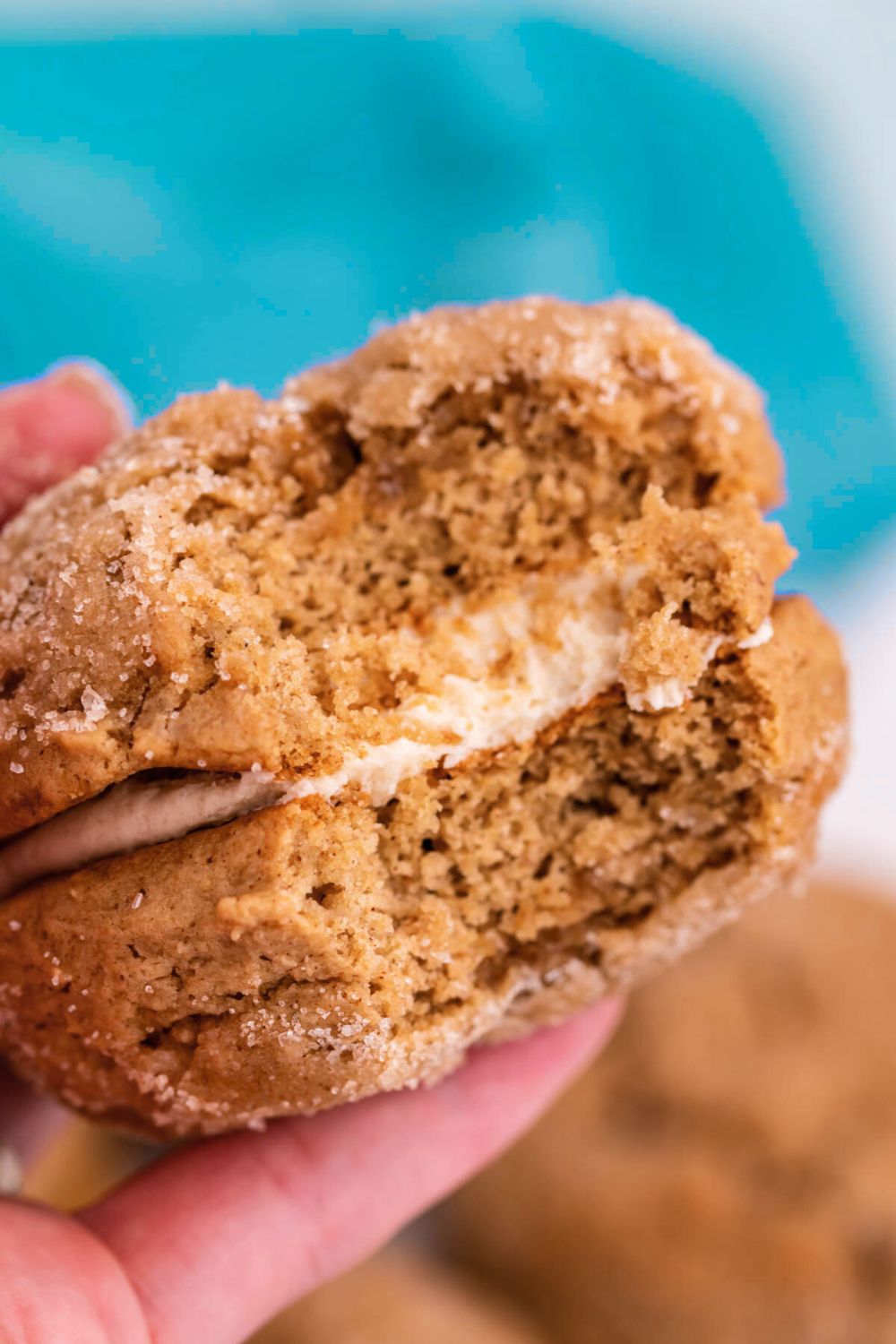 bite taken out of Apple Cider Whoopie Pies being held in a hand 