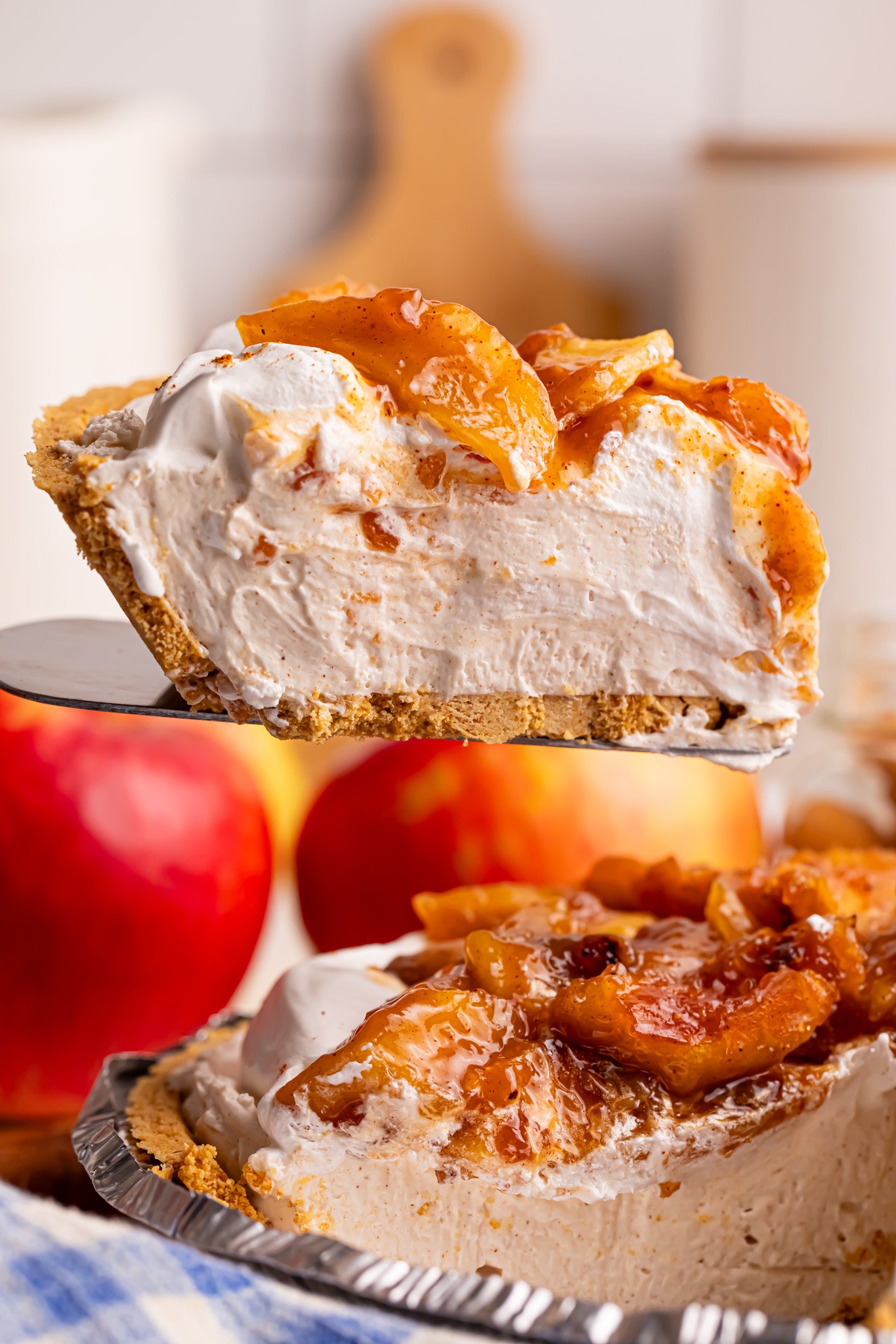 No Bake Apple Cheesecake Pie slice being lifted up from the baking dish