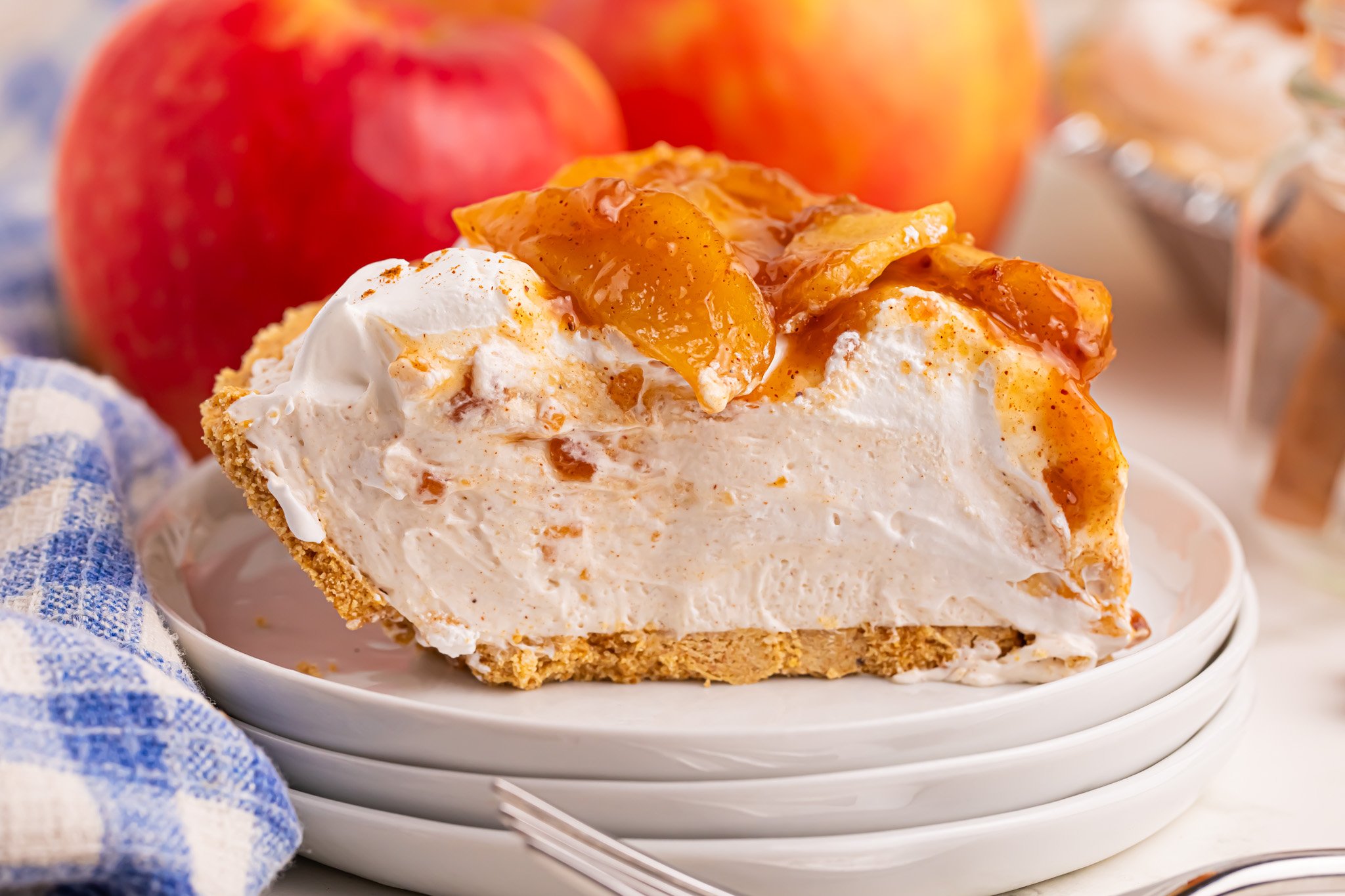 No Bake Apple Cheesecake pie slice on a pile of white plates