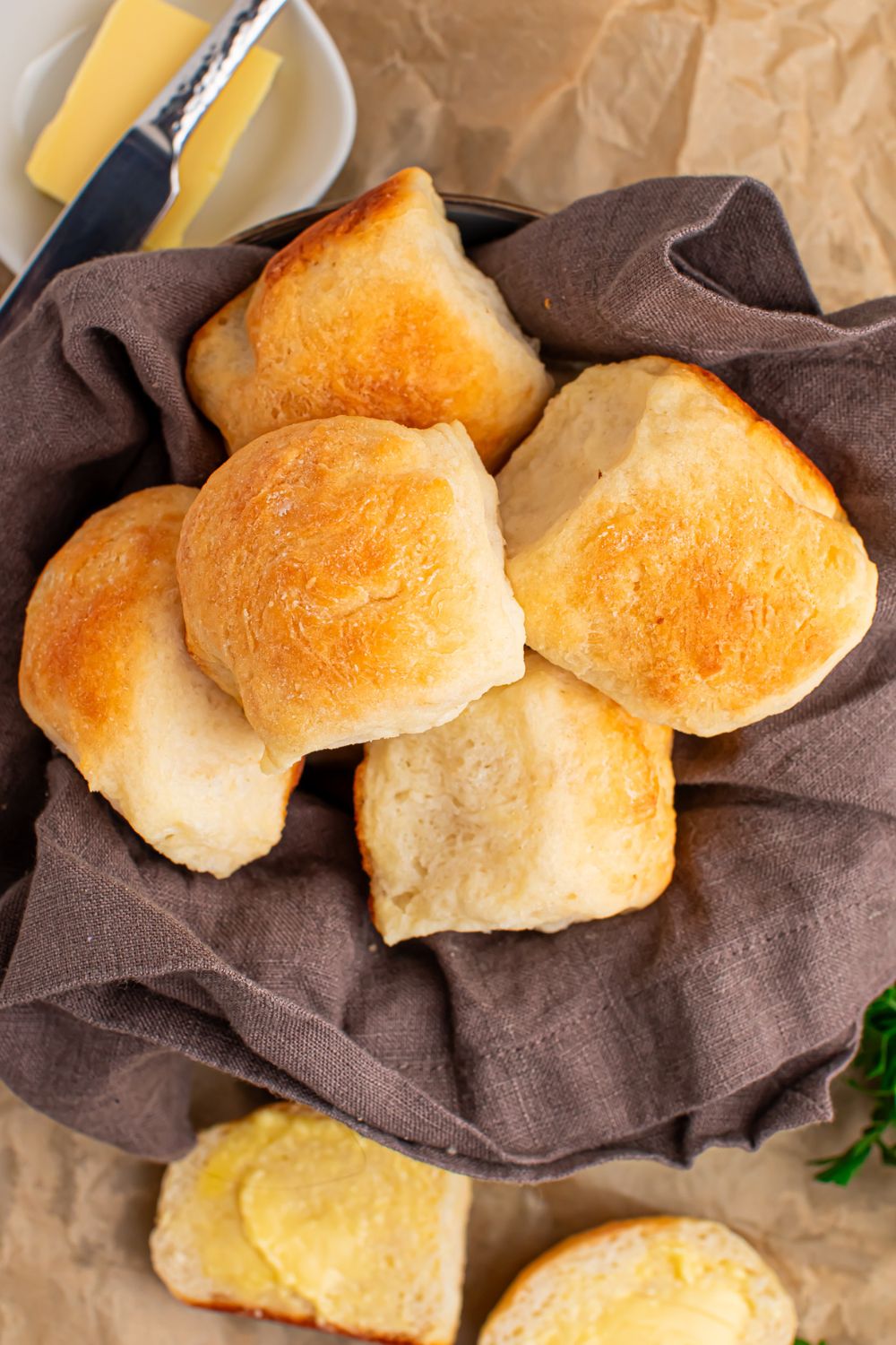 2 Ingredient Dinner Rolls in a basket on table with butter to side of basket 