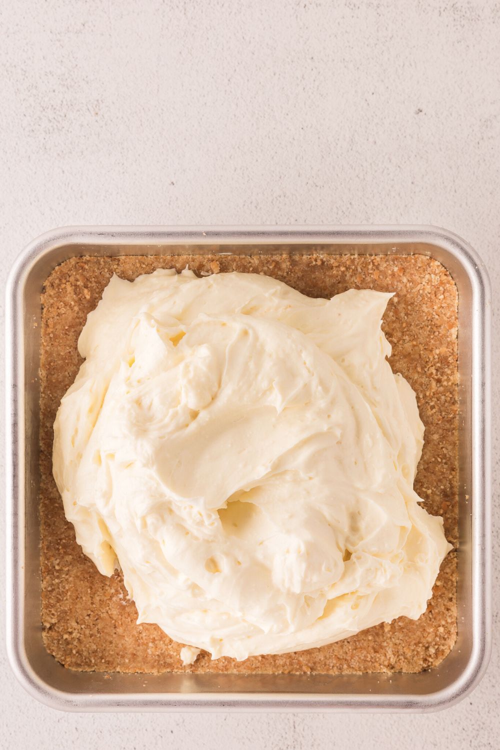 crust with cheesecake filling placed on top of crust 