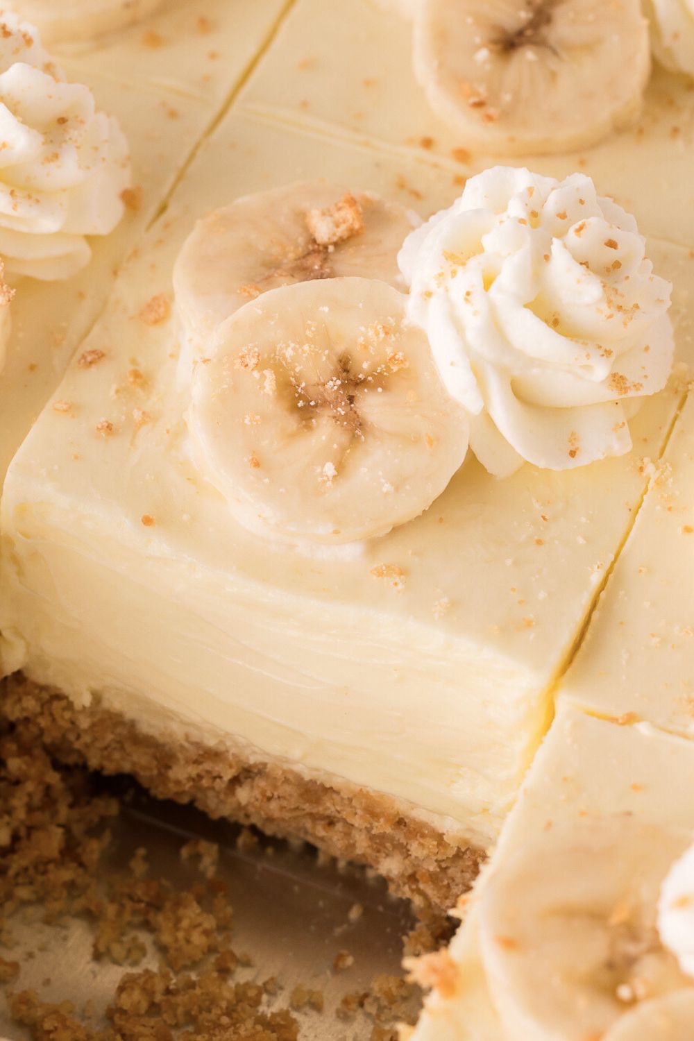 close up of sliced No Bake Banana Pudding Cheesecake Bars in a pan 