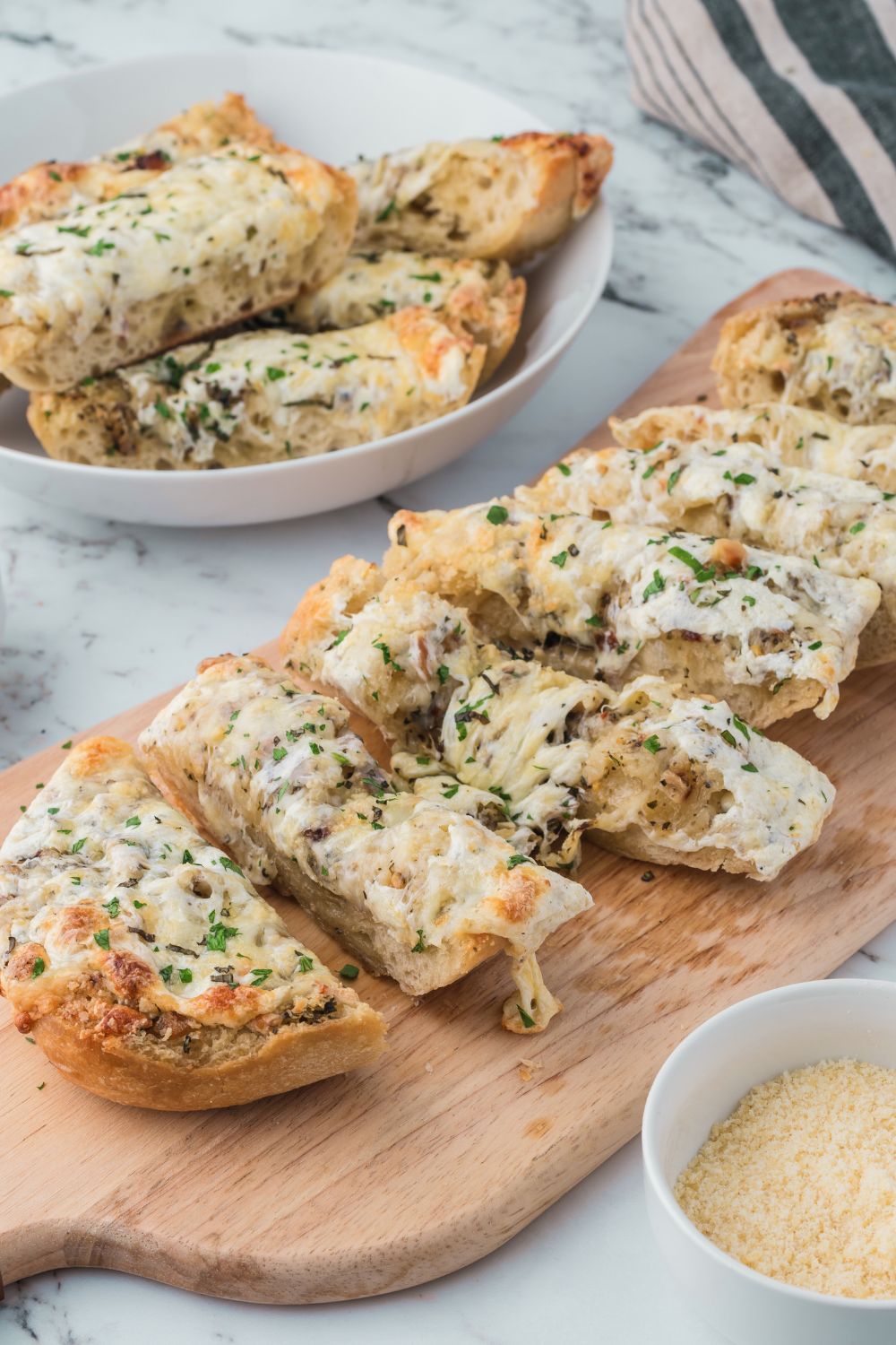 Cheesy Garlic Bread sliced into strips sitting on table 