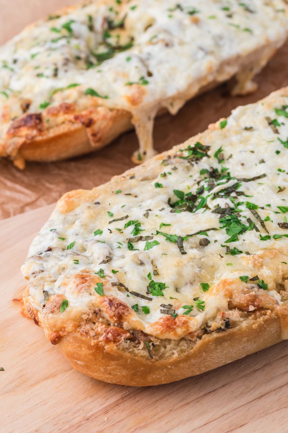 side view of French bread Cheesy Garlic Bread  on tray on table 