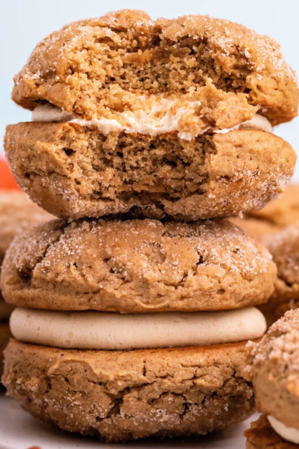 stack of Apple Cider Whoopie Pies on table with the top one with a bite taken out of it 