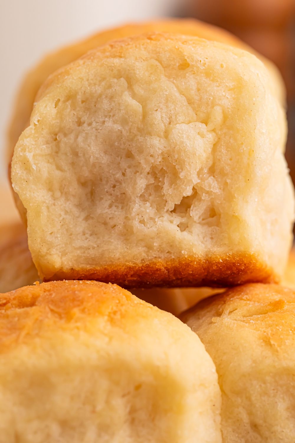 close up of 2 Ingredient Dinner Rolls stacked on top of one another on table 