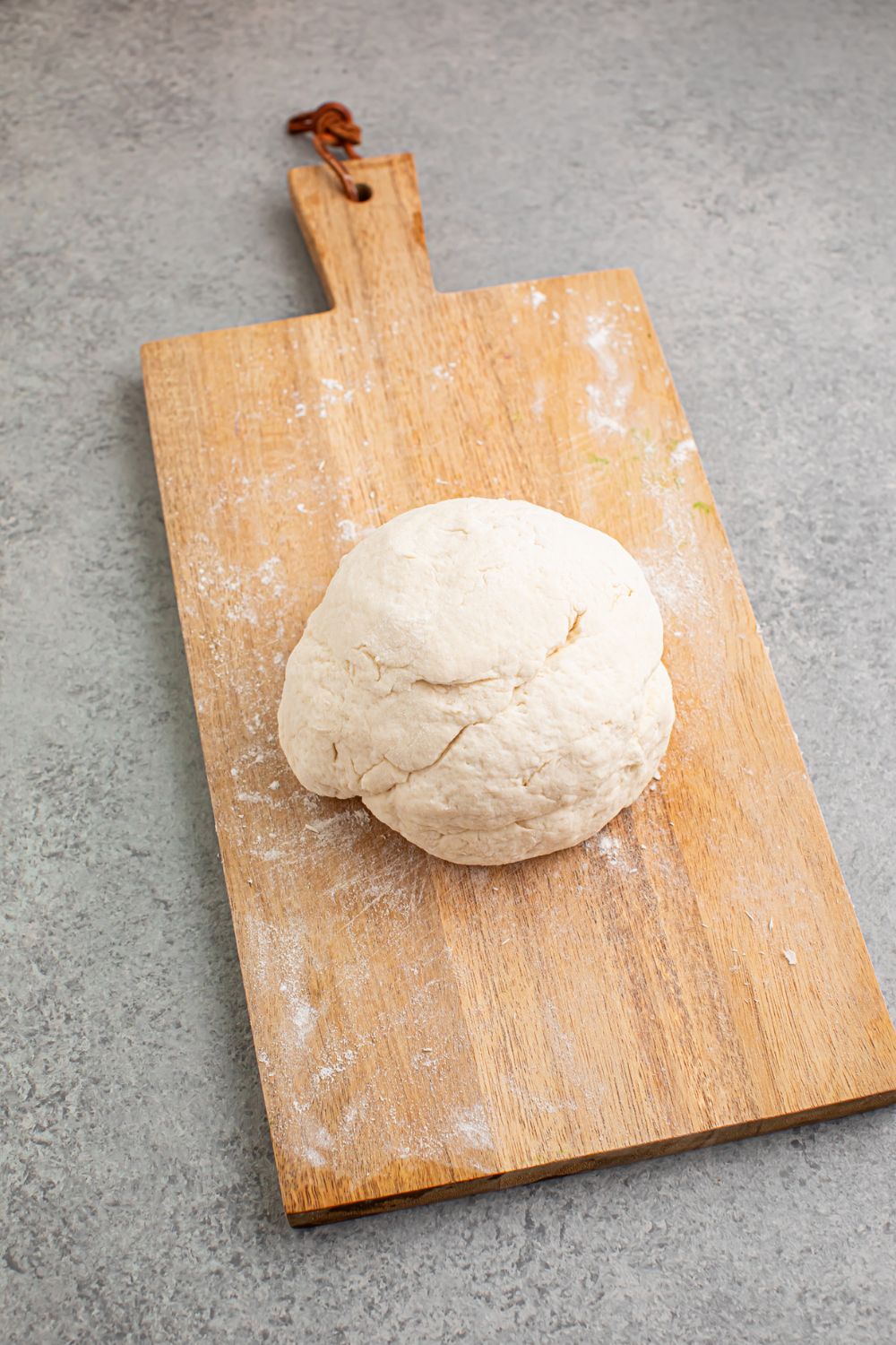 large dough ball on cutting board 