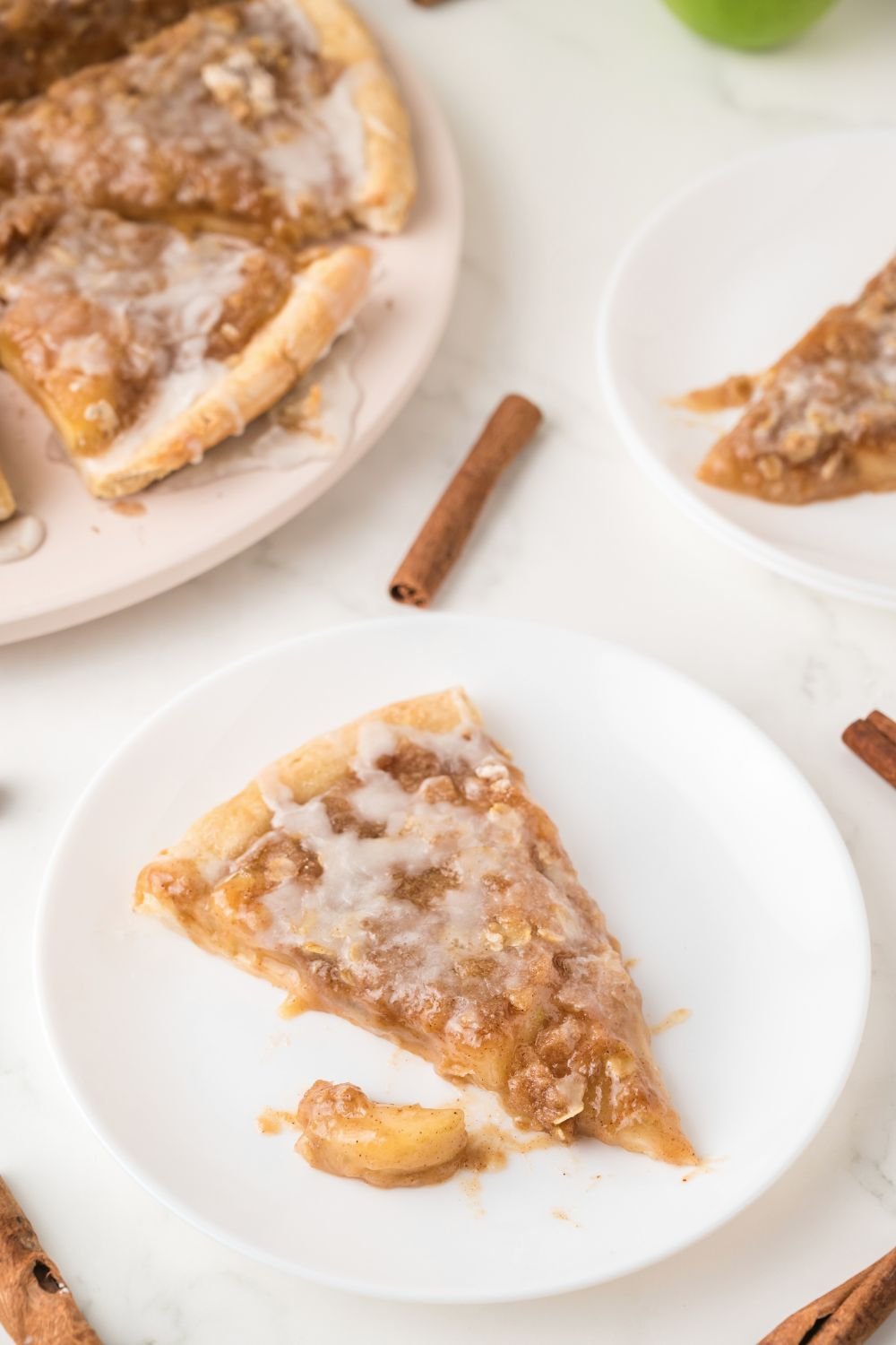 Apple Pie Pizza on table and a slice on a plate 