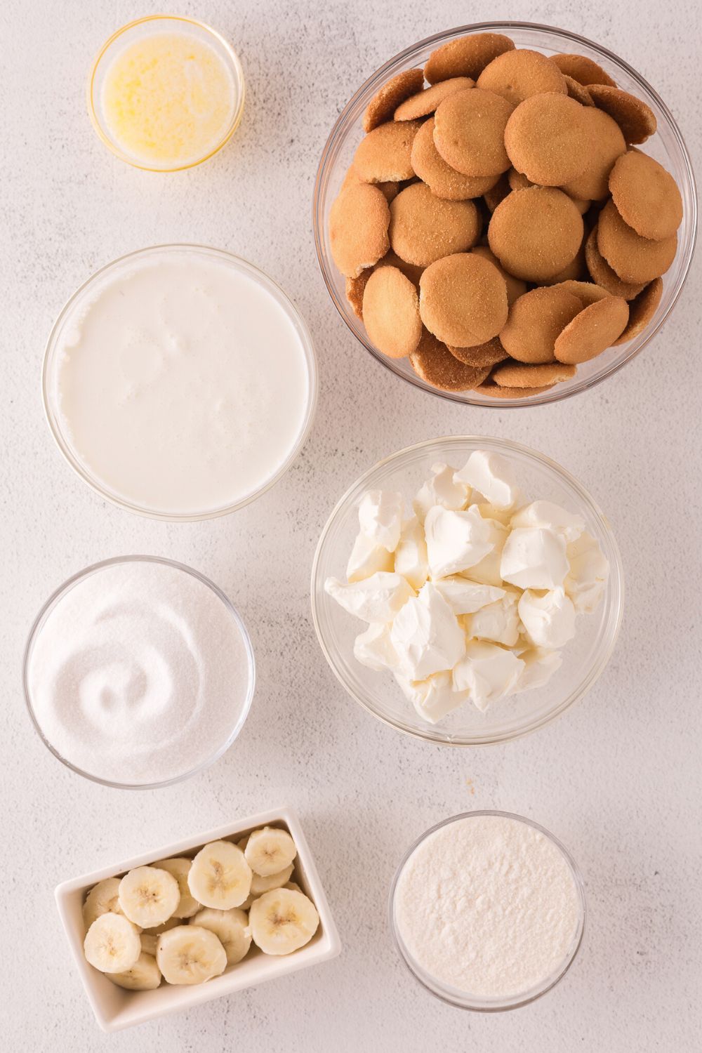 ingredients in small bowls on table for No Bake Banana Pudding Cheesecake Bars