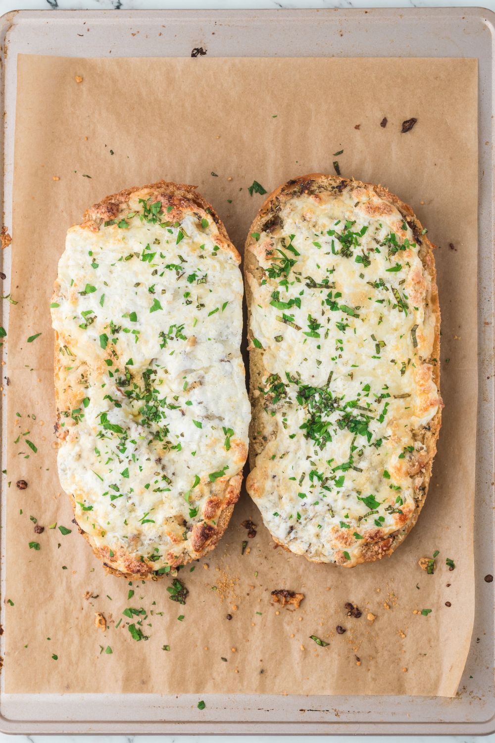 oven baked Cheesy Garlic Bread sitting on baking tray 