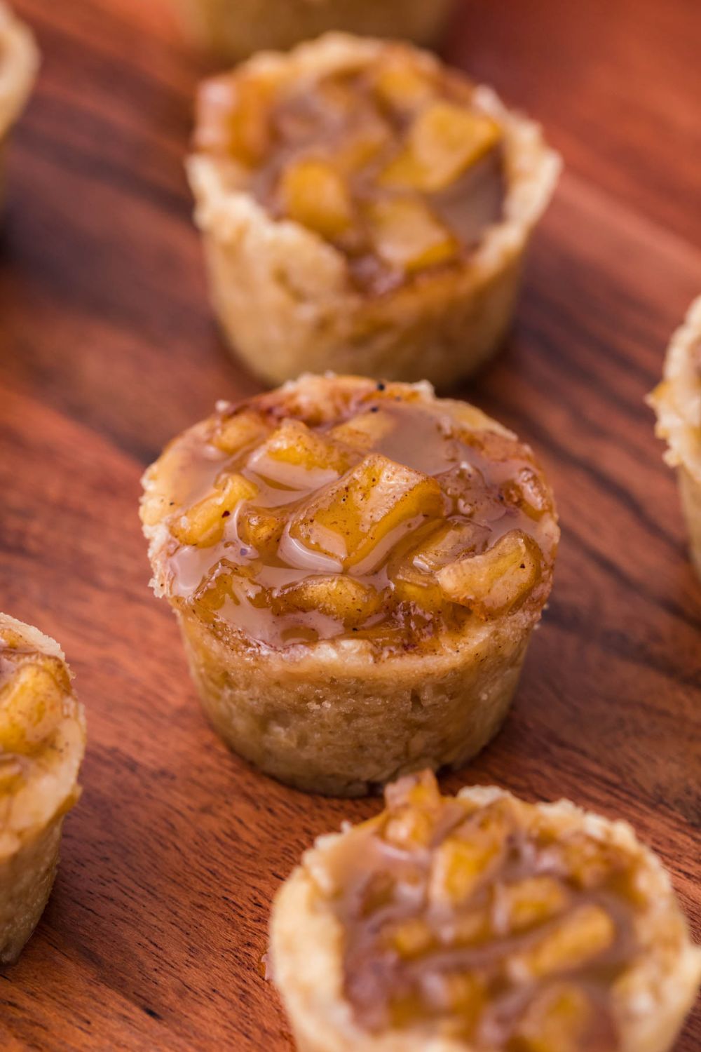 Mini Apple Crisp Bites spread out on a wooden table 
