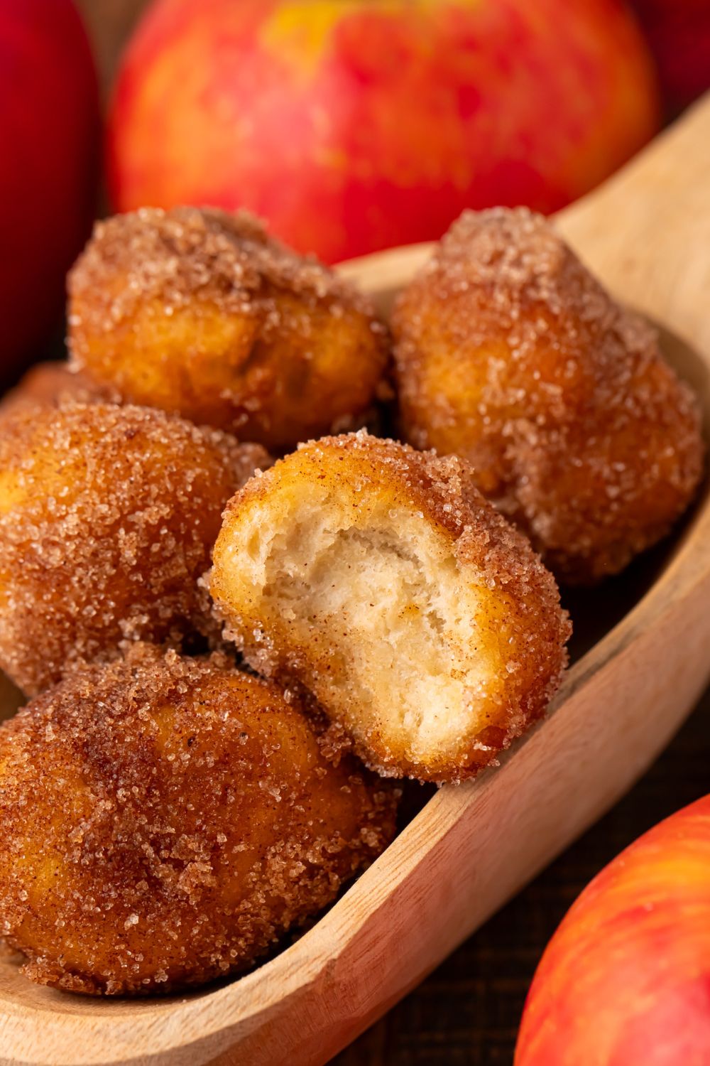 Apple Pie Donut Holes in a basket with a red checked liner sitting on a wooden table