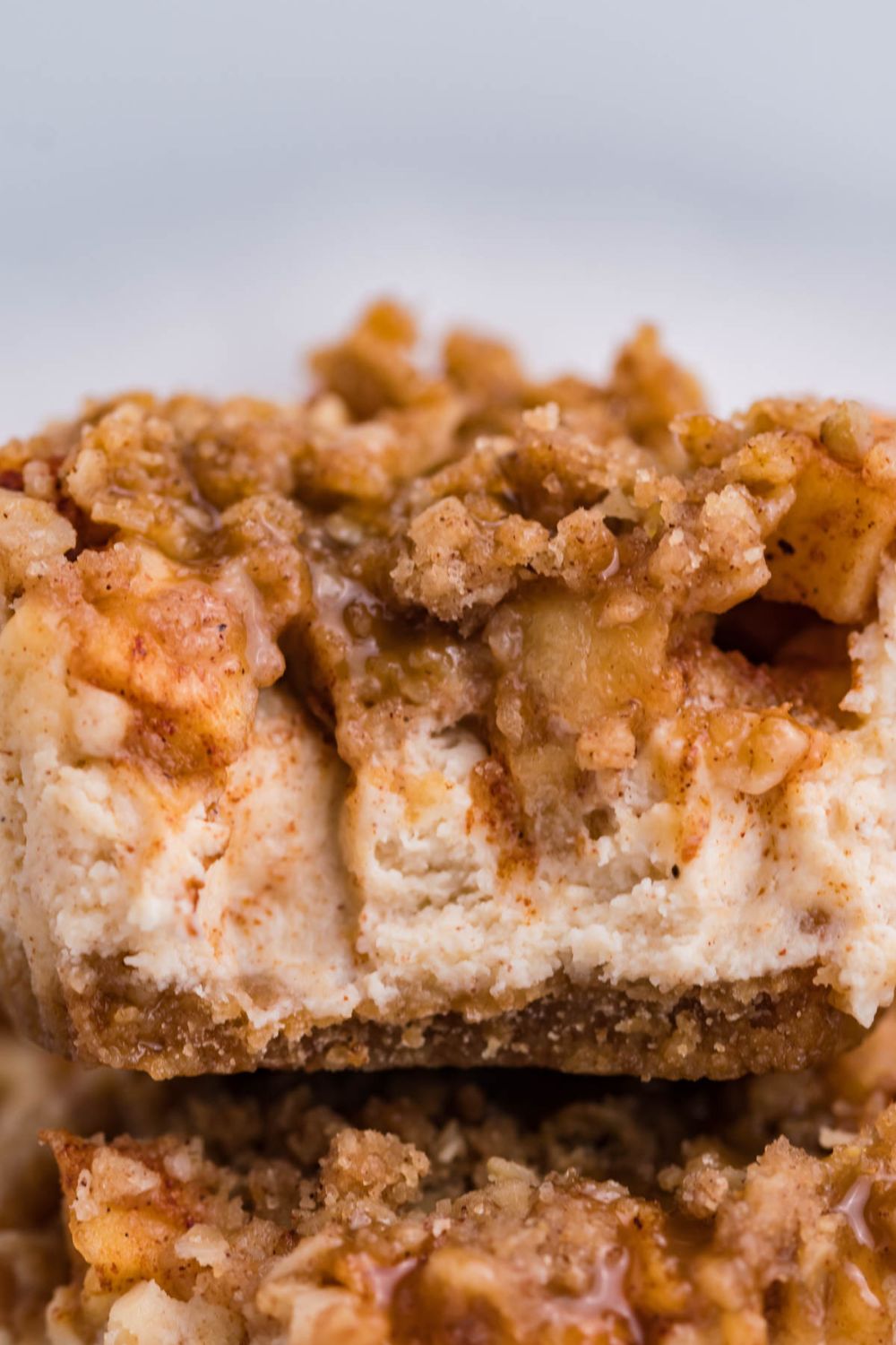 close up of Apple Crisp Cheesecake Bite with part of a bite taken out of it 