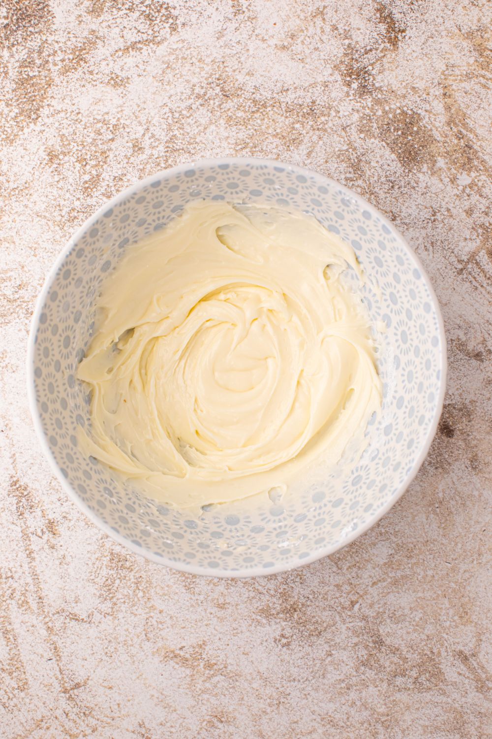 powdered sugar glaze in a white bowl sitting on counter 