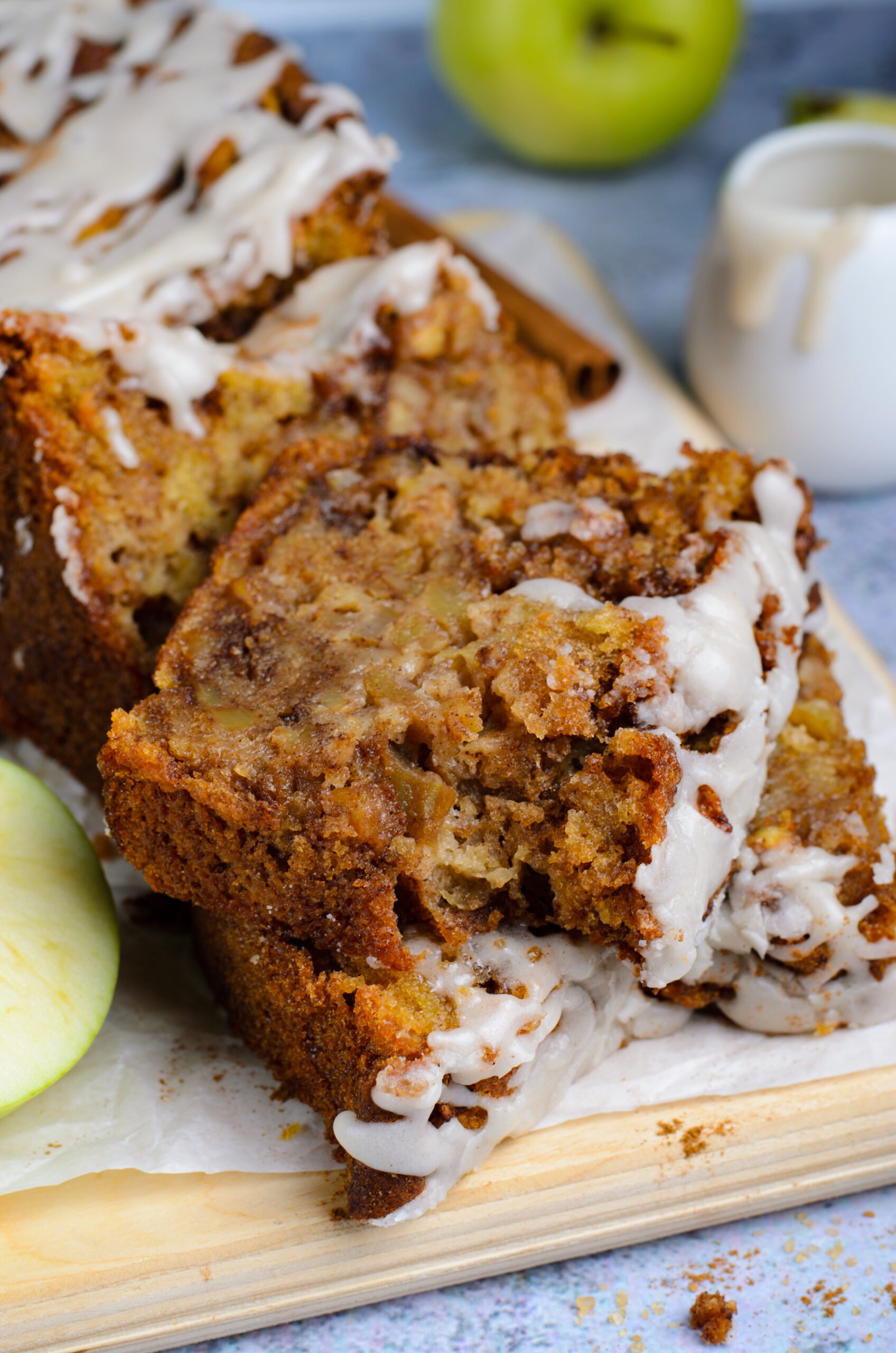 two slices of Amish Apple Fritter Bread on a wooden cutting board 