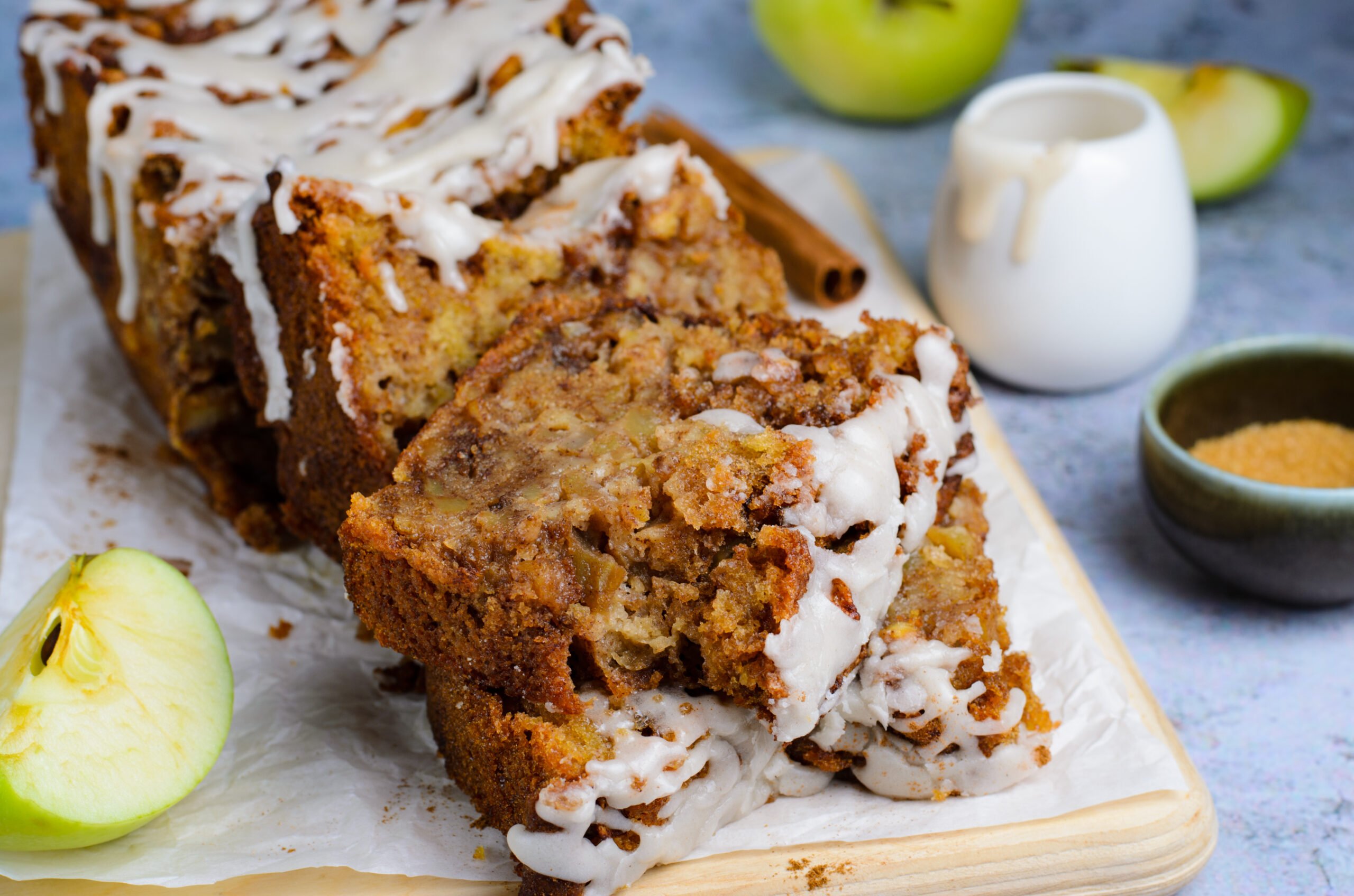 two slices of Amish Apple Fritter Bread on a wooden cutting board 