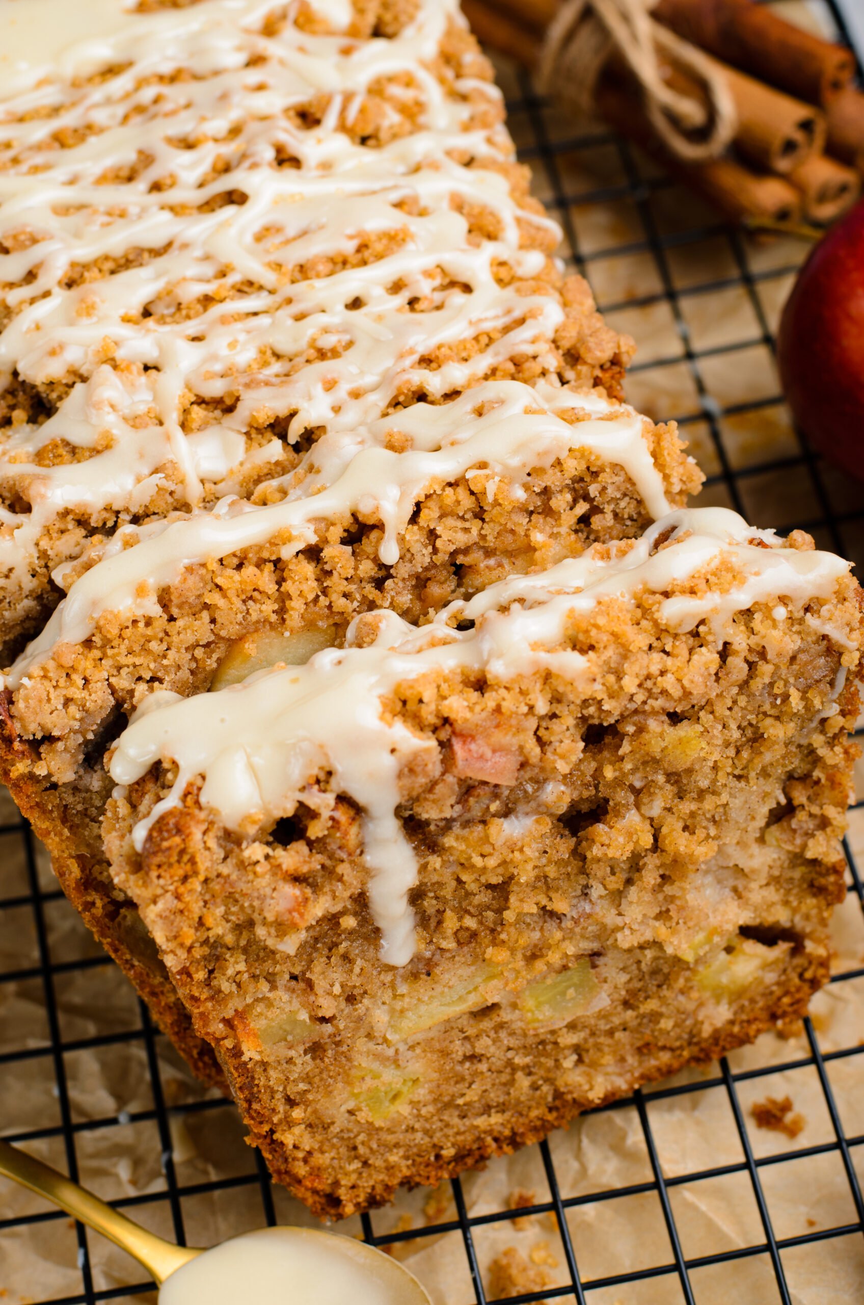 close up view of the entire loaf of  the Apple Cinnamon Loaf Cake  on a black cooling rack 