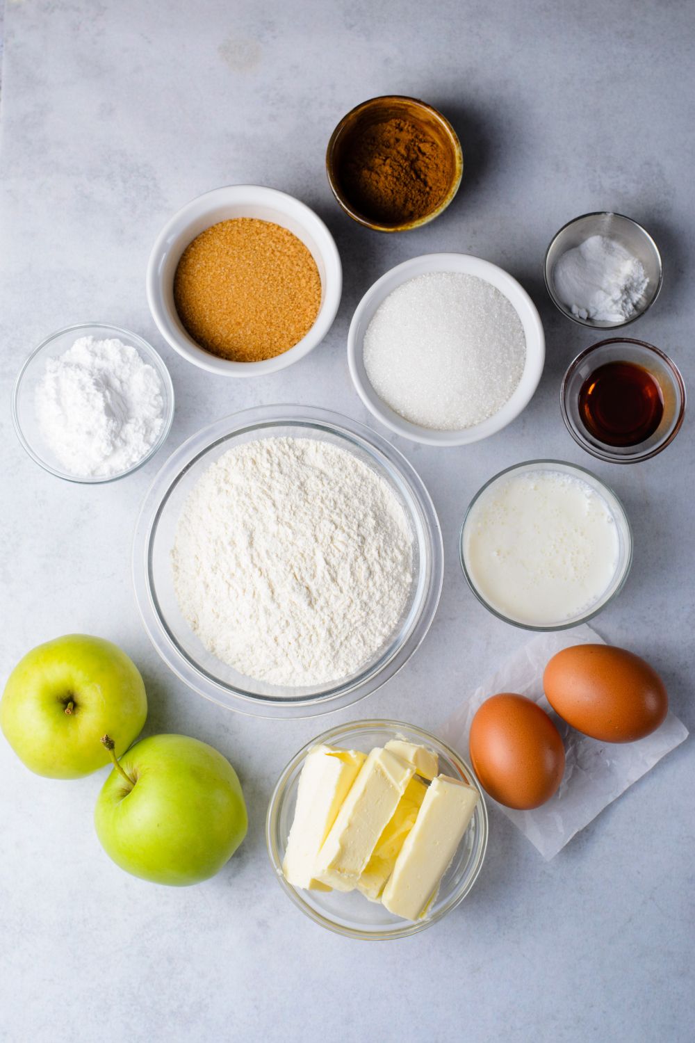 ingredients in single serve containers to make Amish Apple Fritter Bread on a marble counter 
