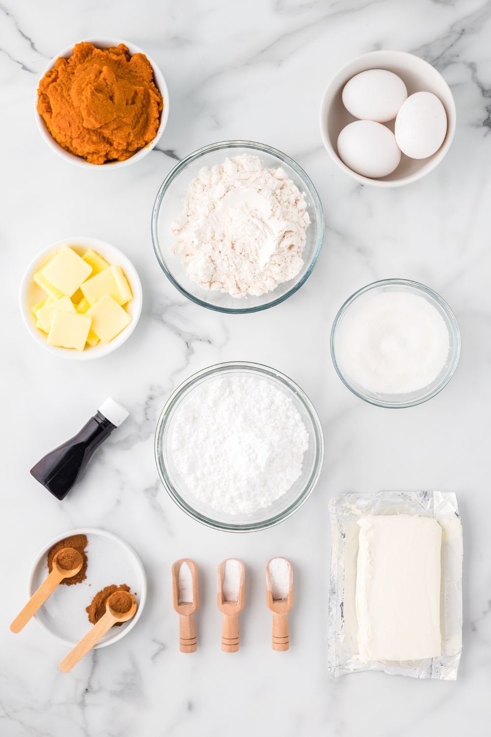 All the ingredients for Pumpkin Cake Roll in single serve containers on table to show all the ingredients you will need. 