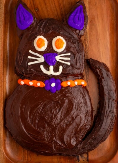 Halloween Black Cat Cut Out Cake on serving tray sitting on table