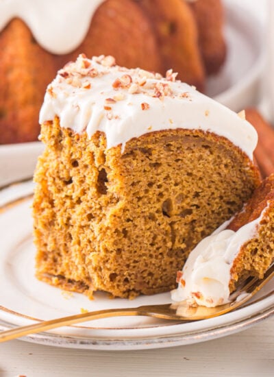 Pumpkin Bundt Cake with Cream Cheese Frosting on a white serving plate