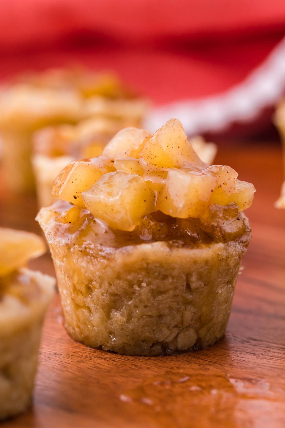 side view of a apple dessert cup with a red towel behind the background