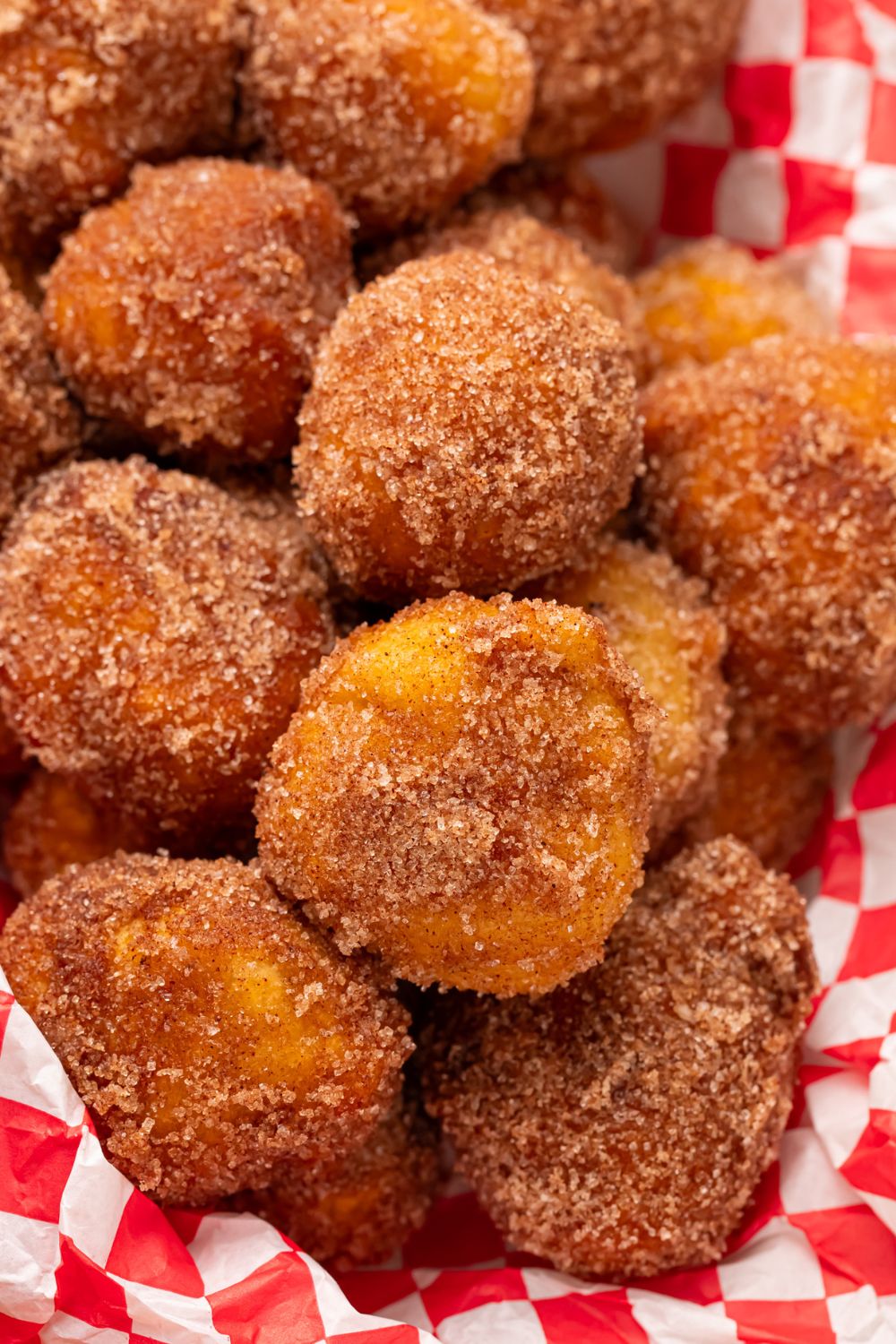 basket with Apple Pie Donut Holes in it coated in cinnamon and sugar 