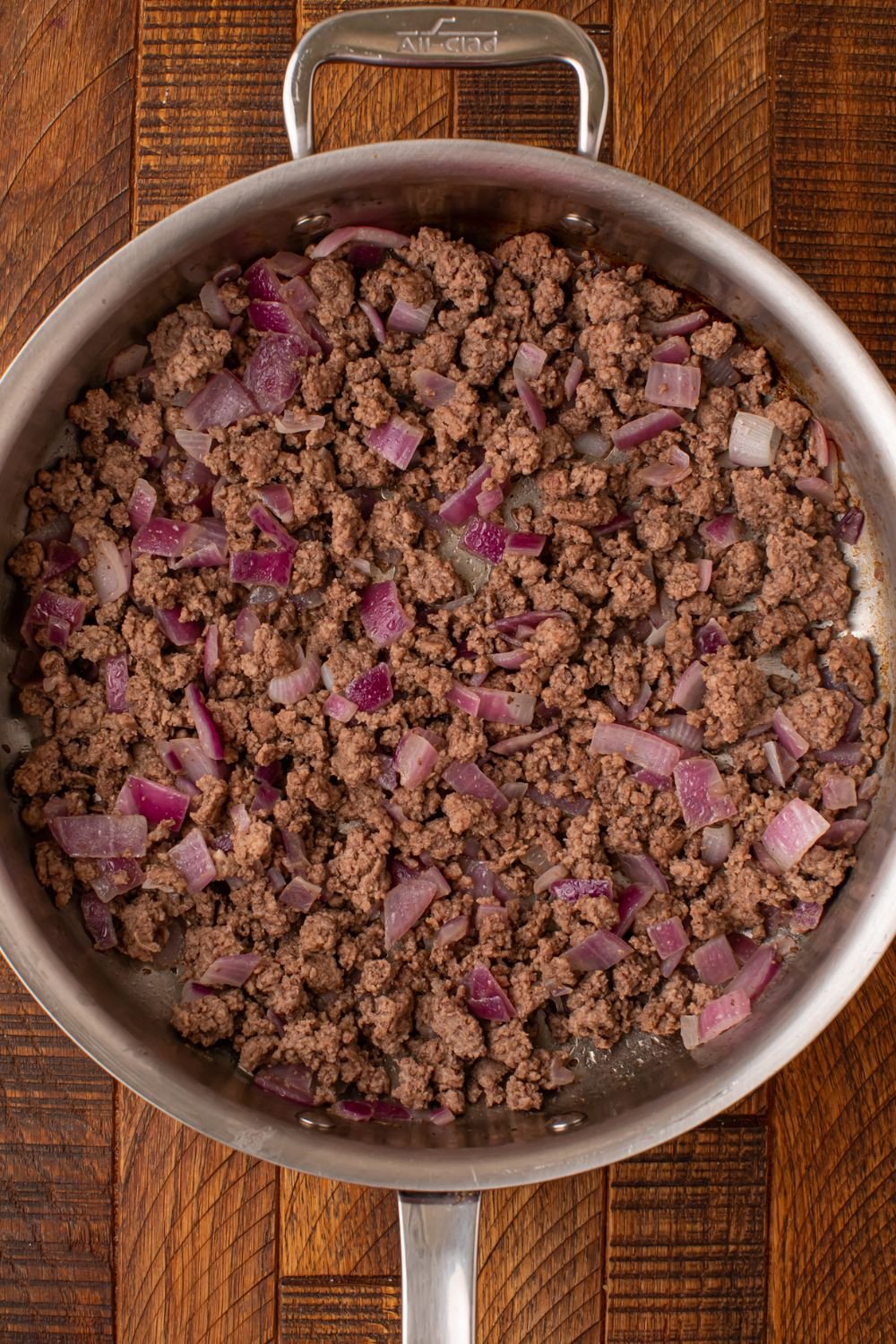 cooked ground beef with peppers in a skillet sitting on the table