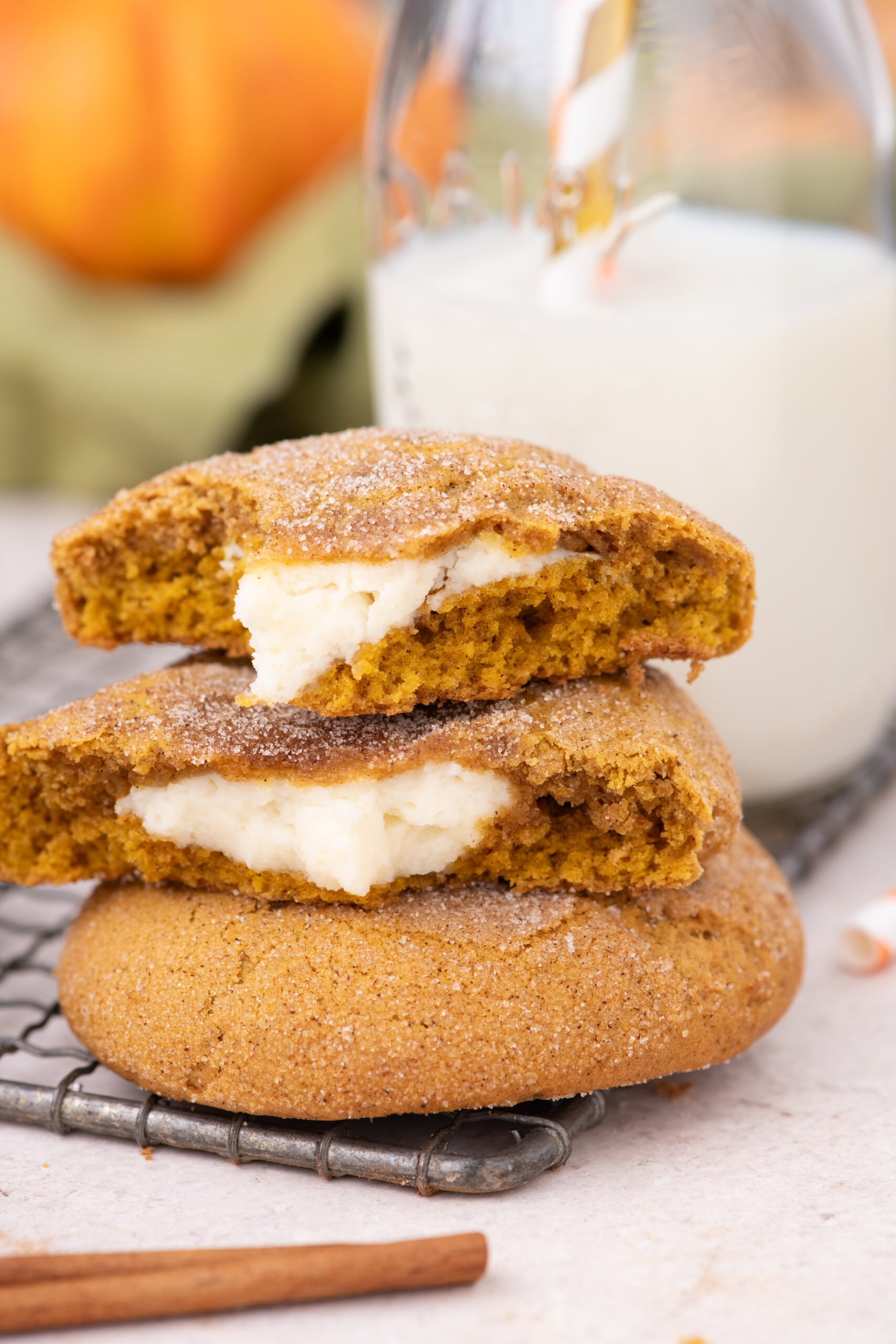 Pumpkin Cheesecake Cookies stacked on a cooling rack