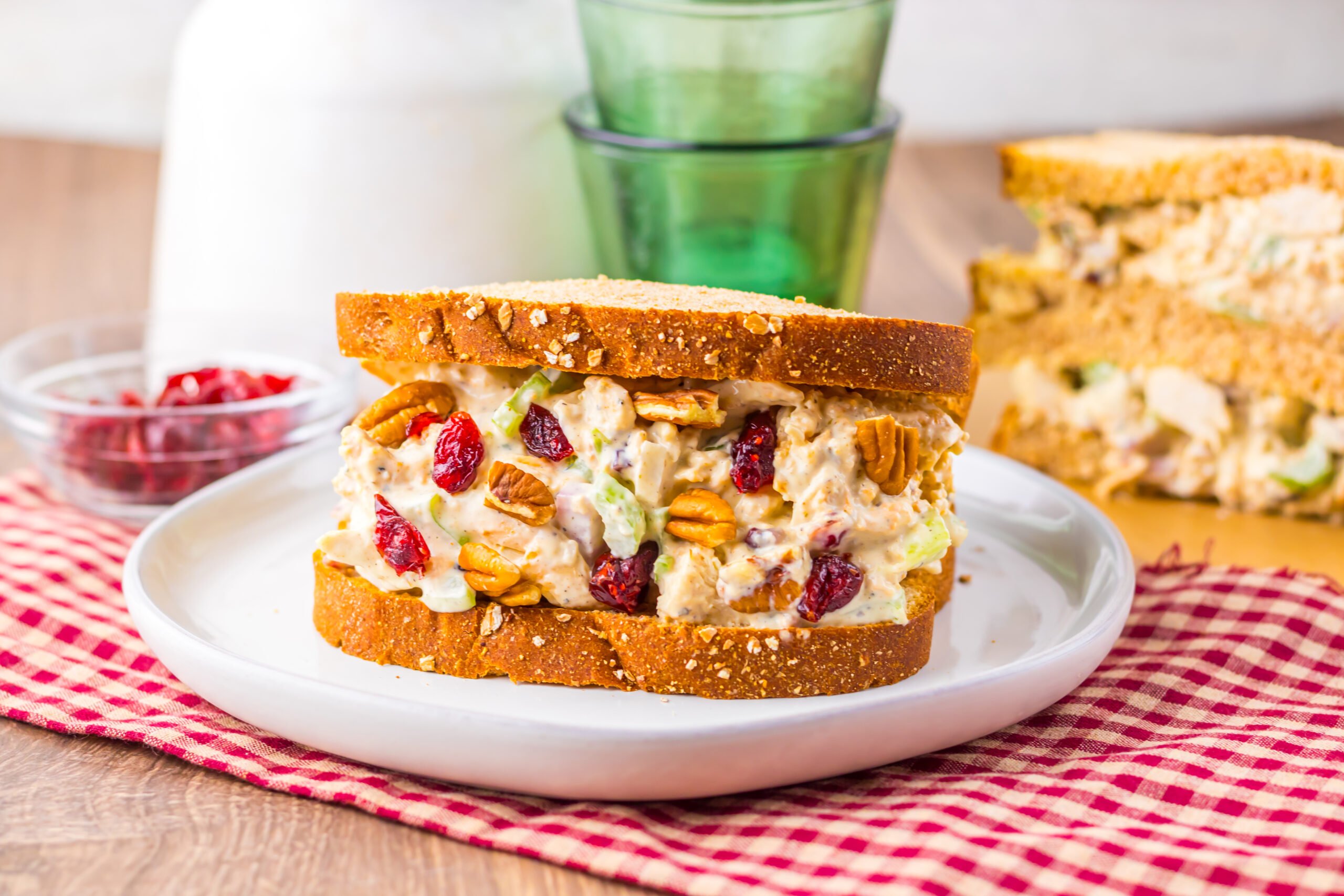 Turkey salad sandwich with cranberries, pecans, and celery on whole grain bread