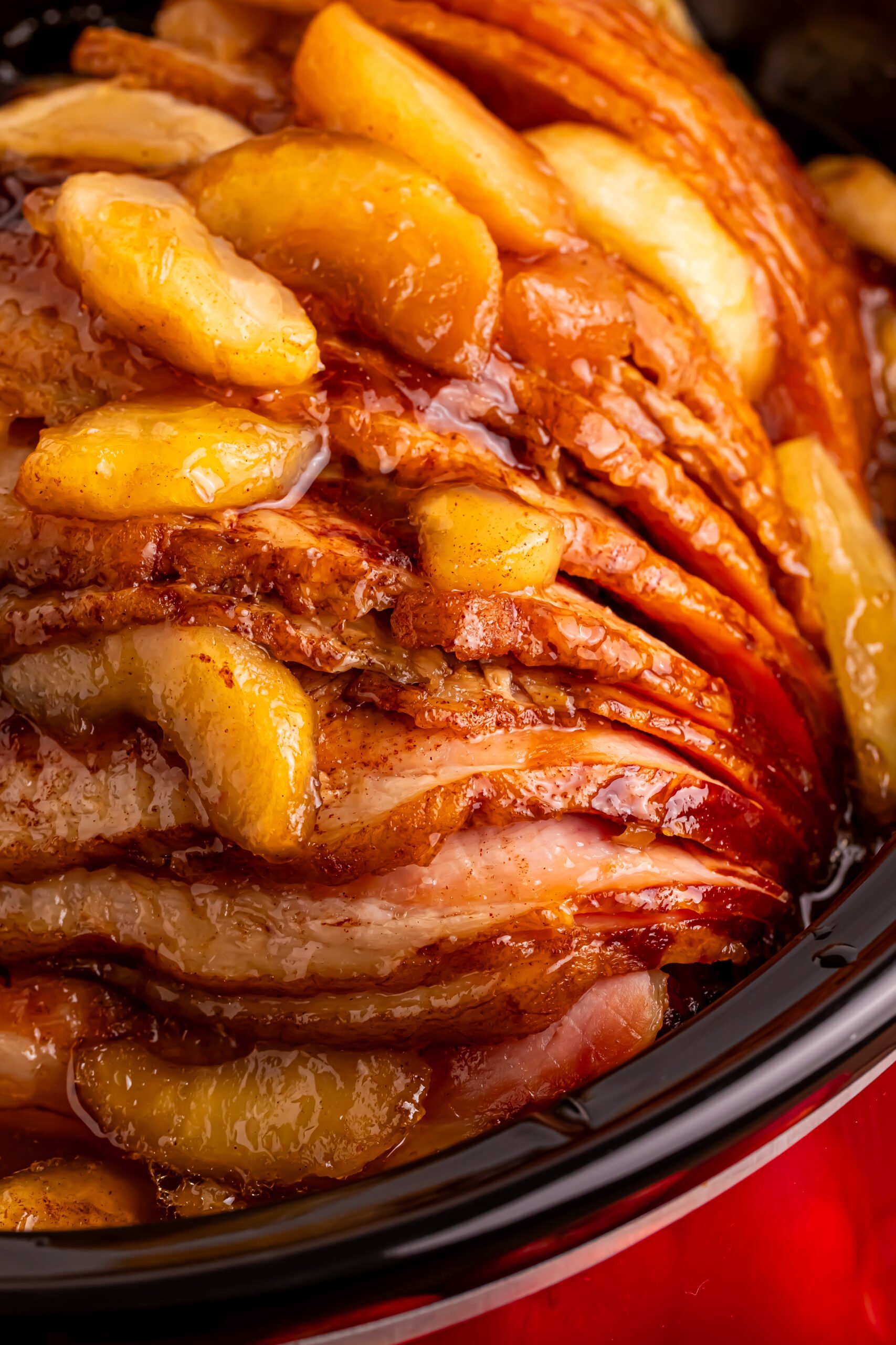 up close shot of the Slow Cooker Apple Glazed Ham in a black crock pot 
