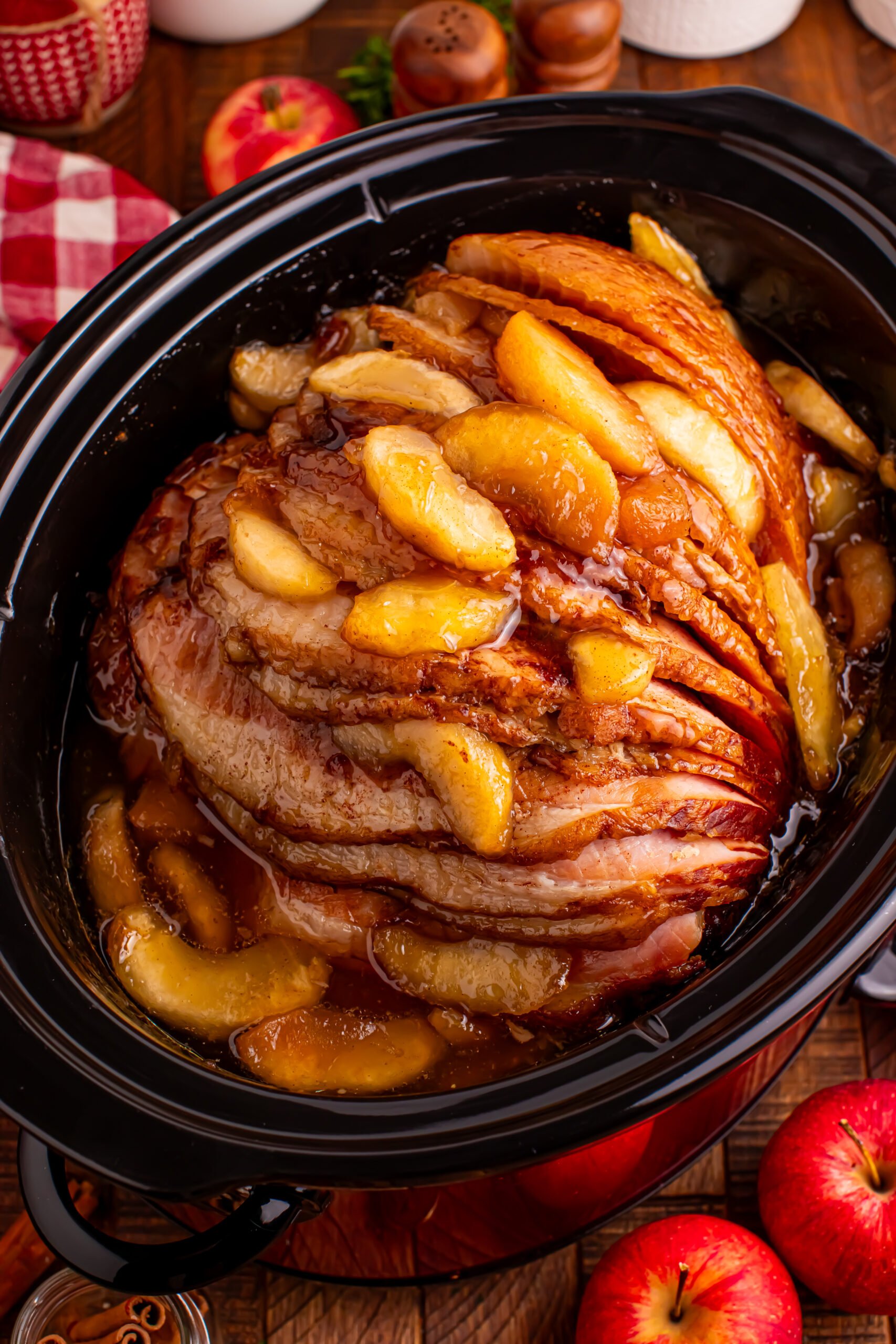 Up close shot of the Slow Cooker Apple Glazed Ham topped with apples 